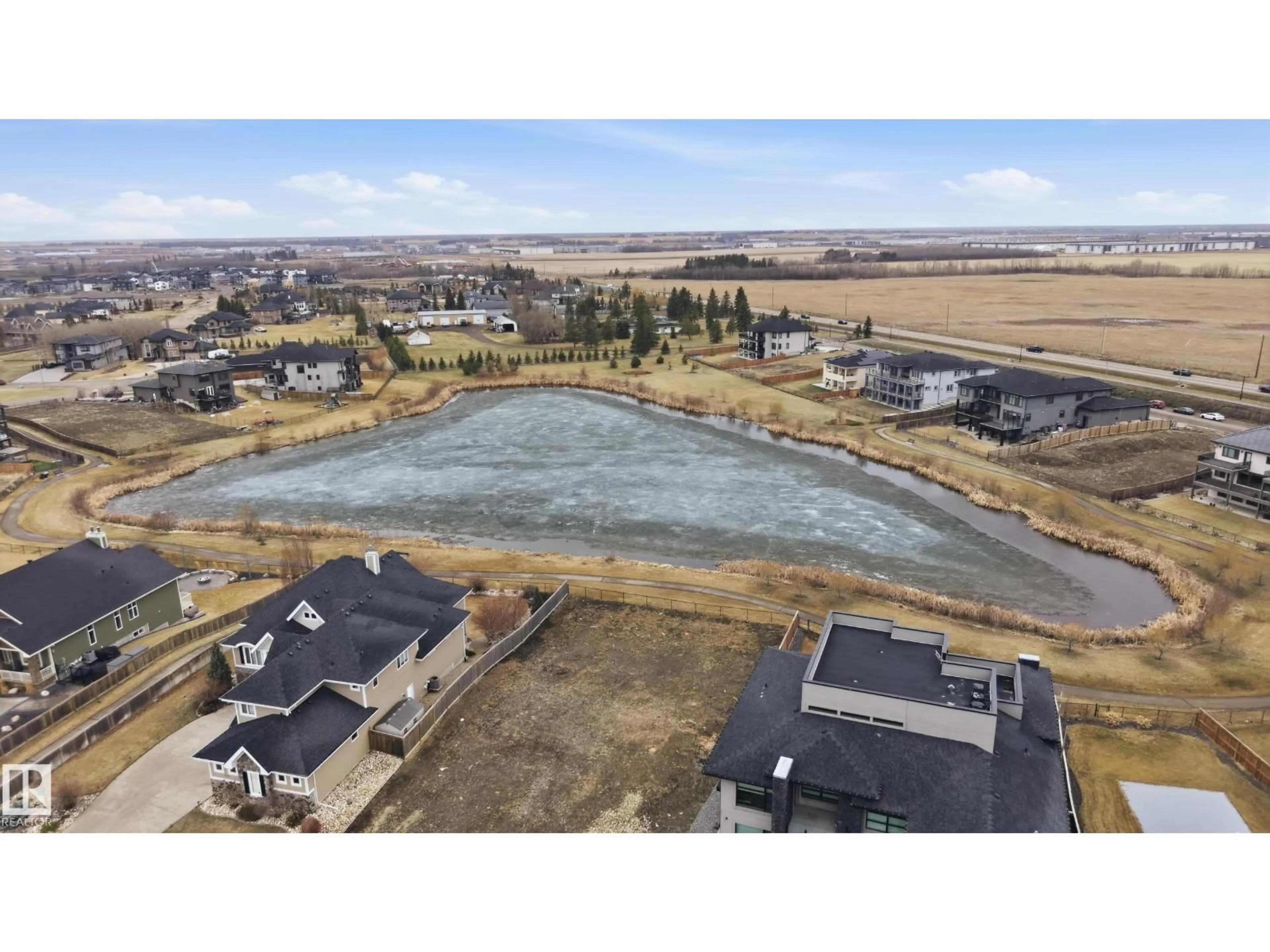 A pic from outside/outdoor area/front of a property/back of a property/a pic from drone, water/lake/river/ocean view for 6021 30 ST, Rural Leduc County Alberta T4X0X4
