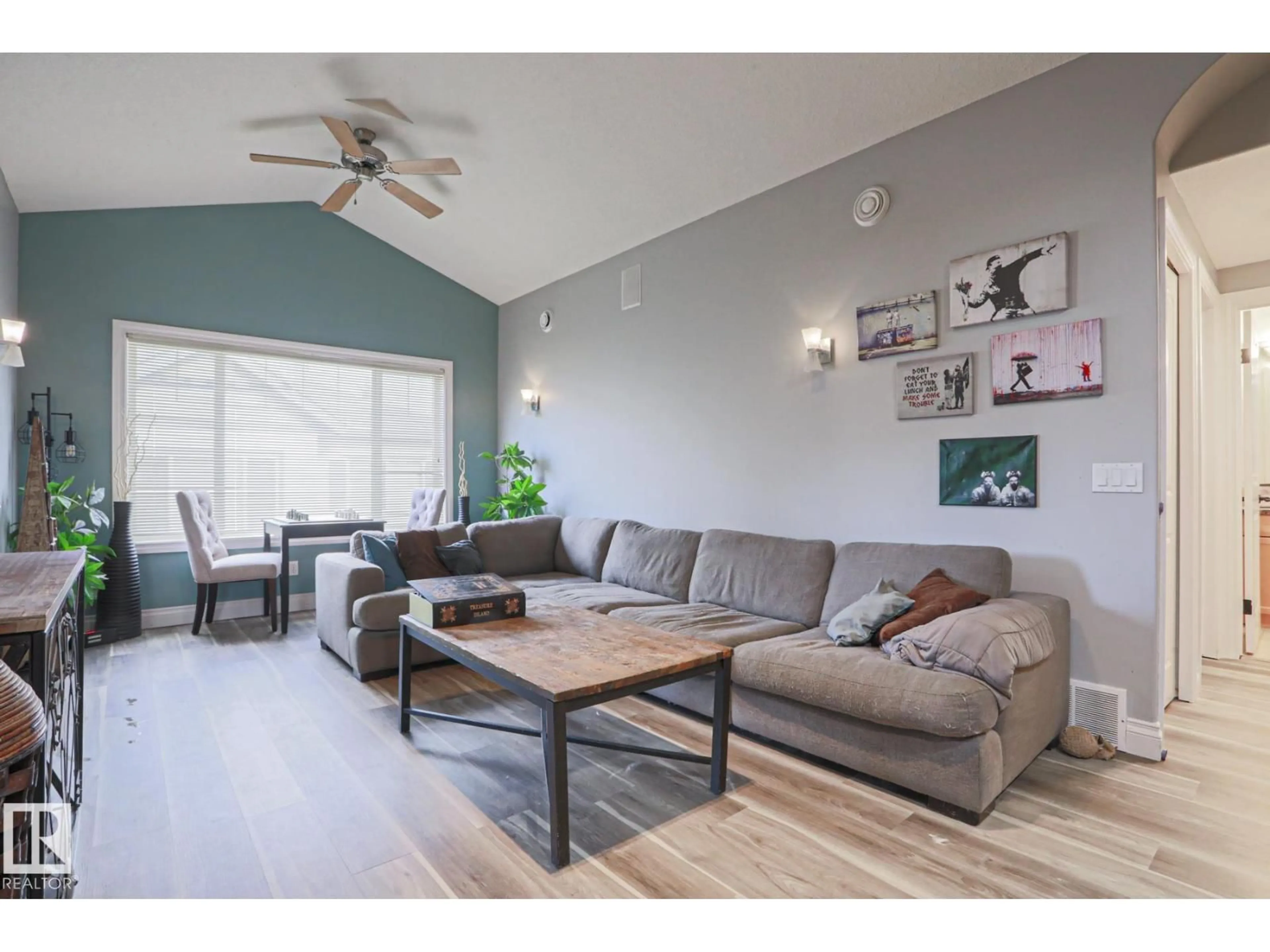 Living room with furniture, wood/laminate floor for #18 - 2565 HANNA CR, Edmonton Alberta T6R0M4