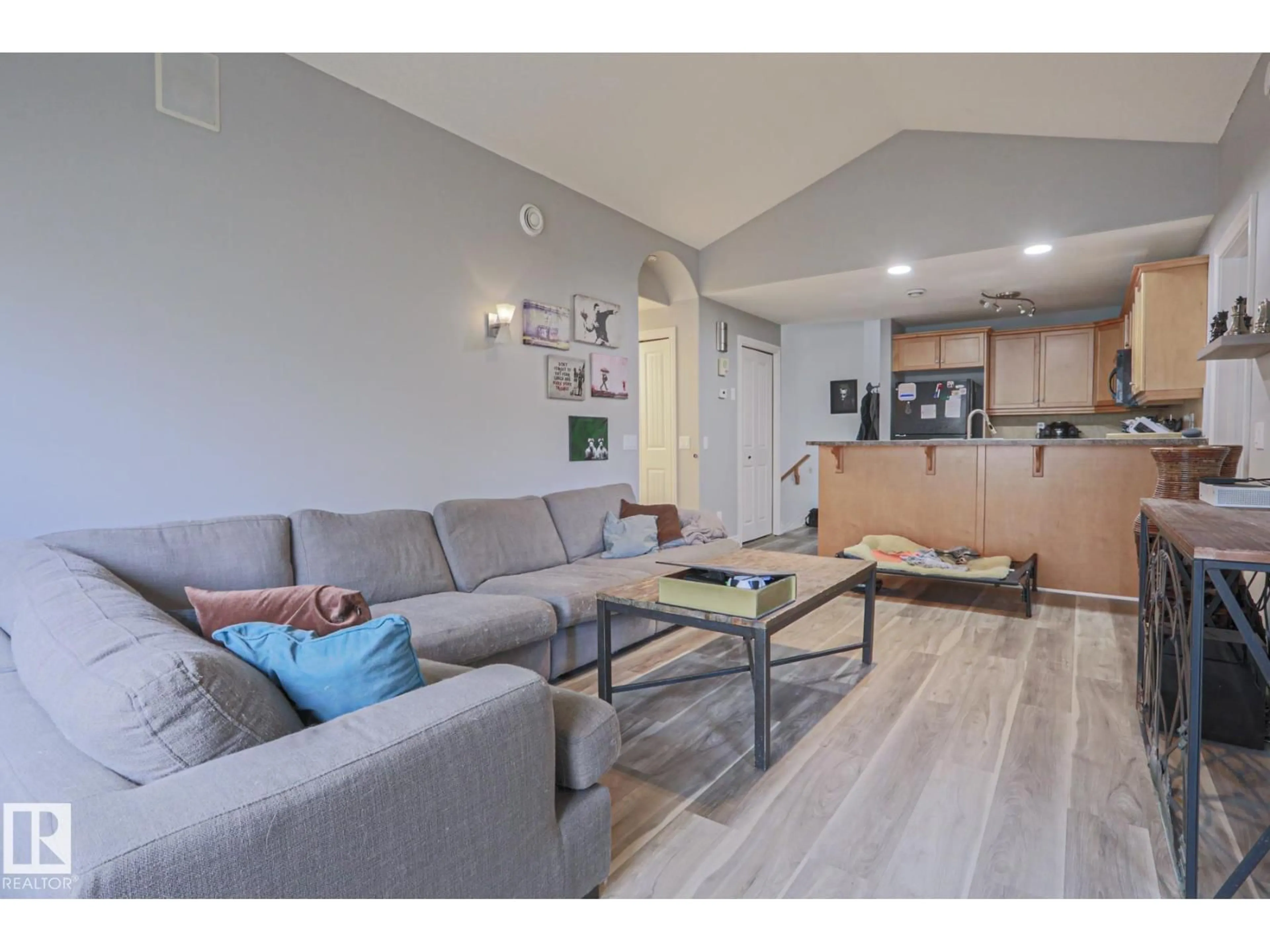 Living room with furniture, wood/laminate floor for #18 - 2565 HANNA CR, Edmonton Alberta T6R0M4