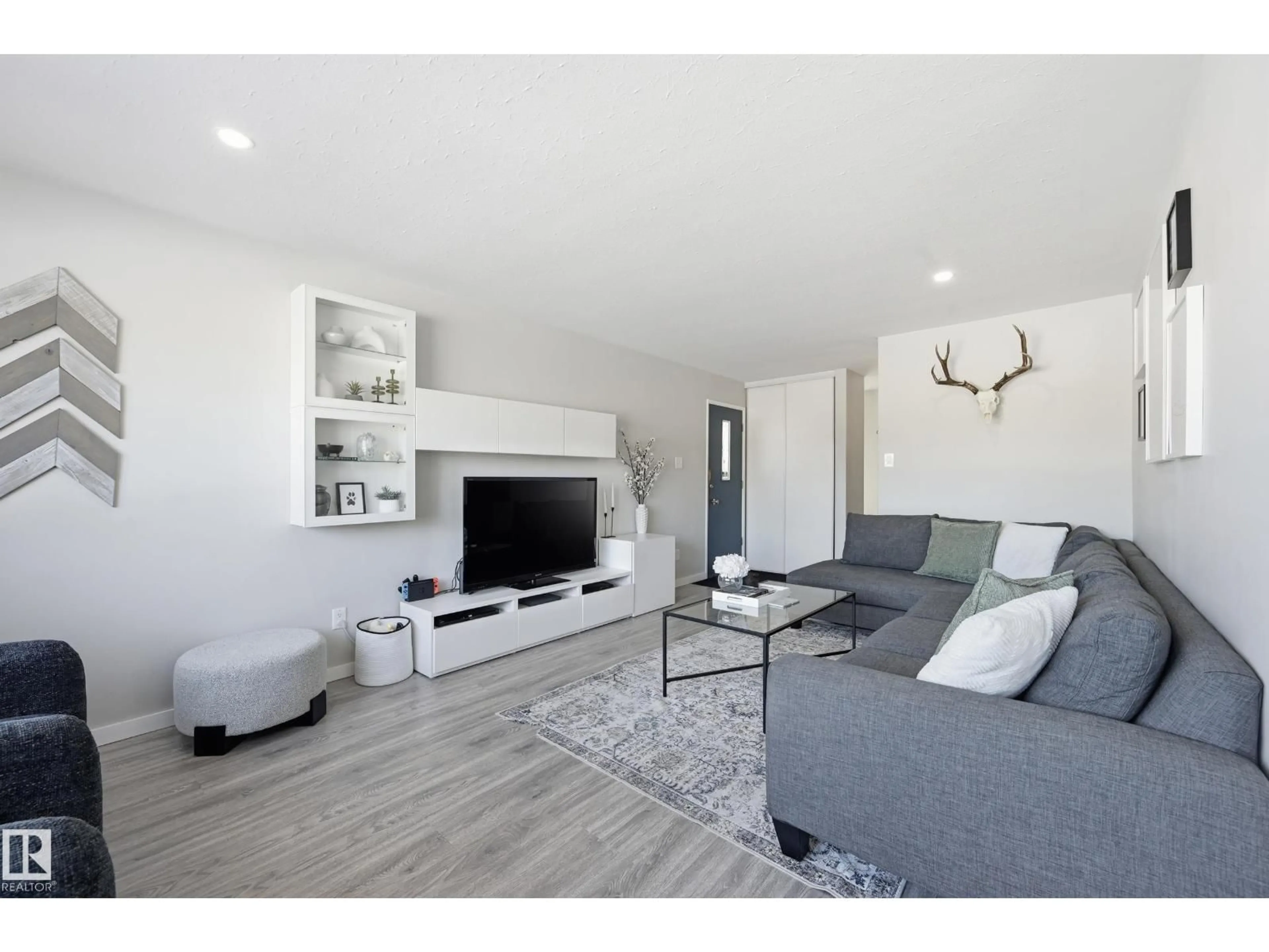 Living room with furniture, wood/laminate floor for 7719 71 AV, Edmonton Alberta T6C0A9