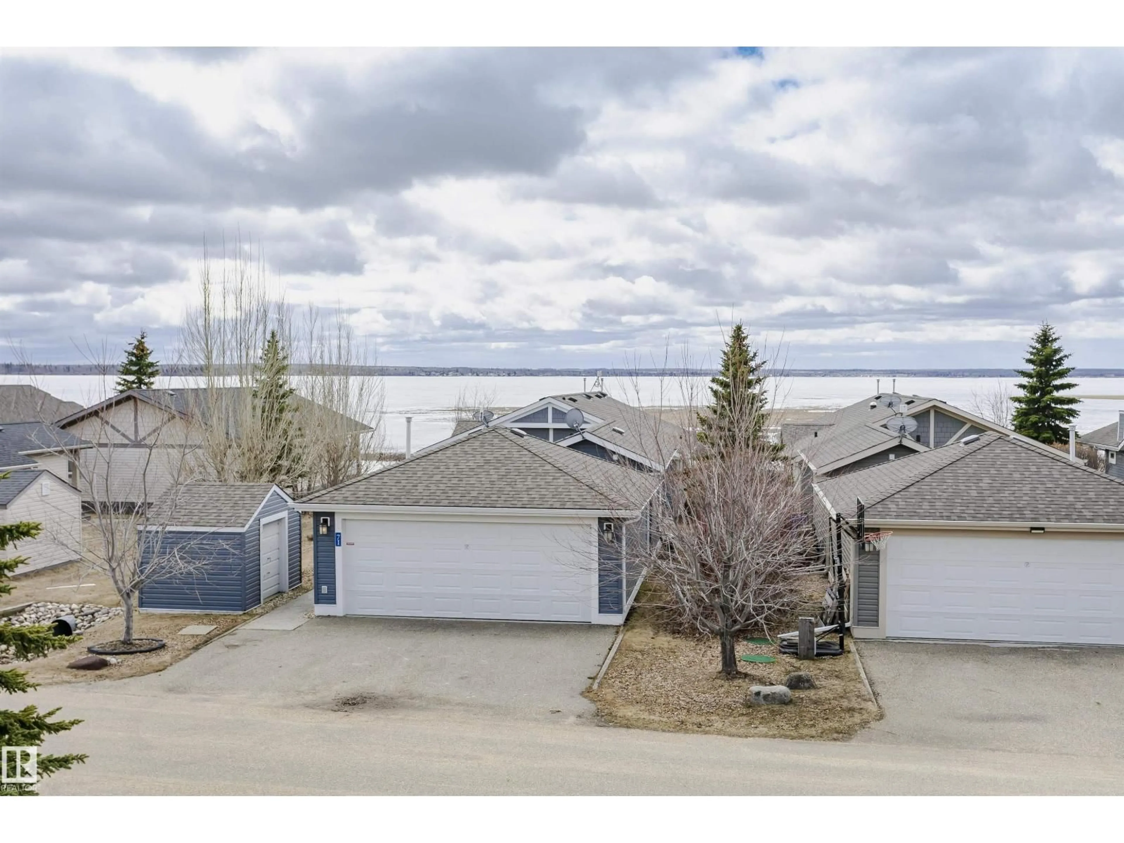 A pic from outside/outdoor area/front of a property/back of a property/a pic from drone, water/lake/river/ocean view for STE. 55101 - 71 ANNE TR, Rural Lac Ste. Anne County Alberta T0E1A1