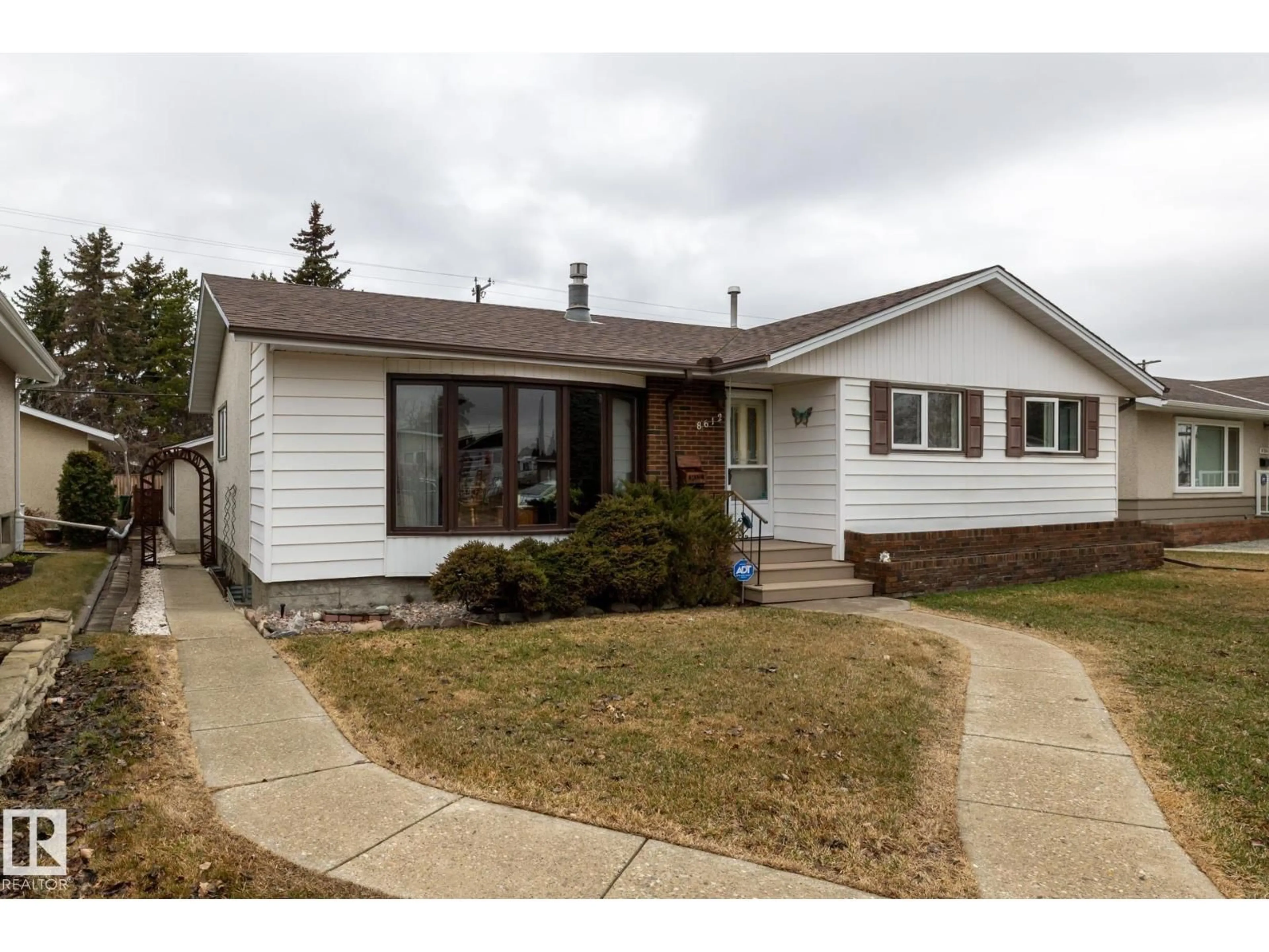 Home with vinyl exterior material, street for NW - 8612 68A ST, Edmonton Alberta T6B1T5