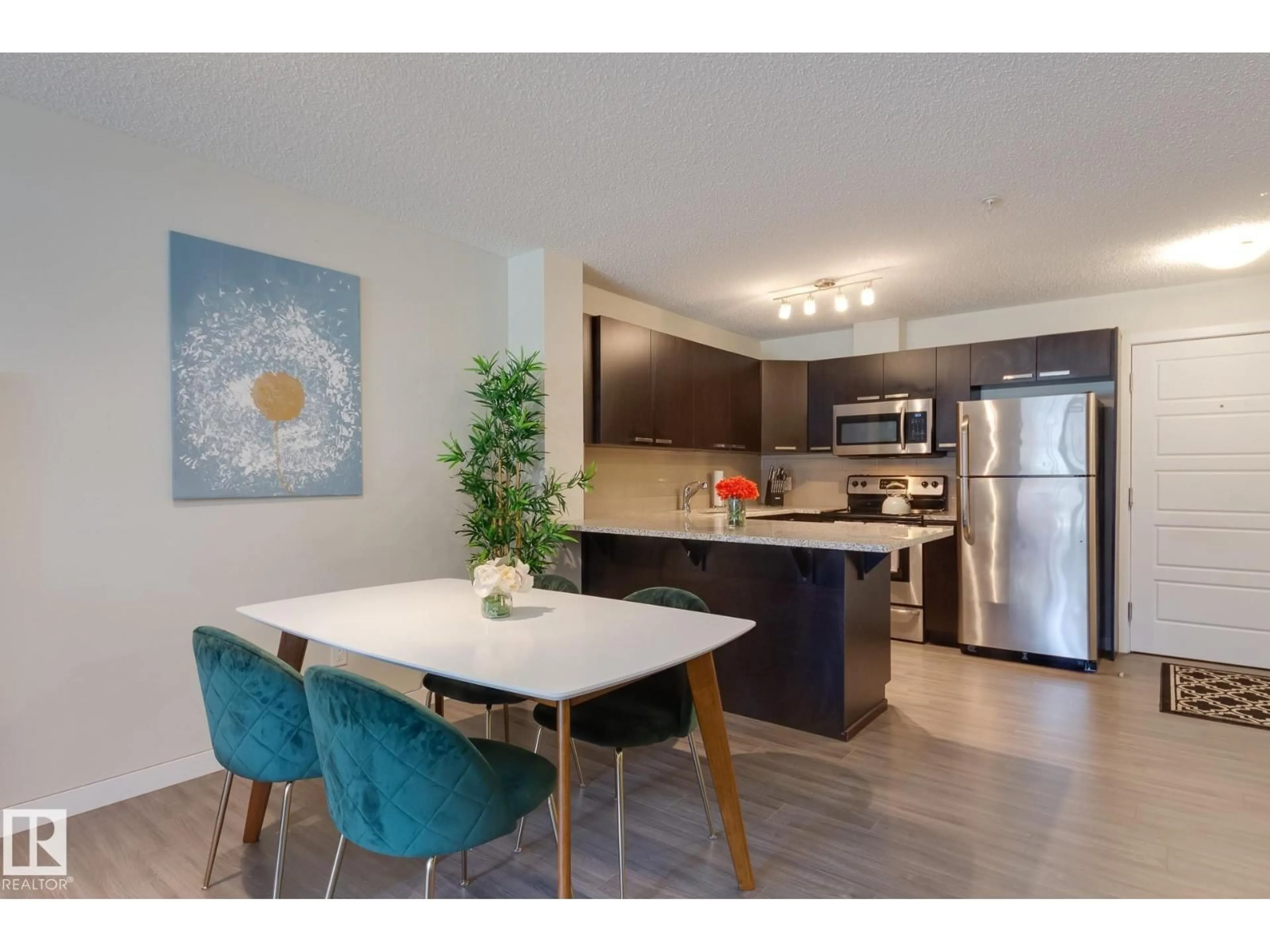 Open concept kitchen, wood/laminate floor for #116 - 14808 125 ST NW, Edmonton Alberta T5X0G1