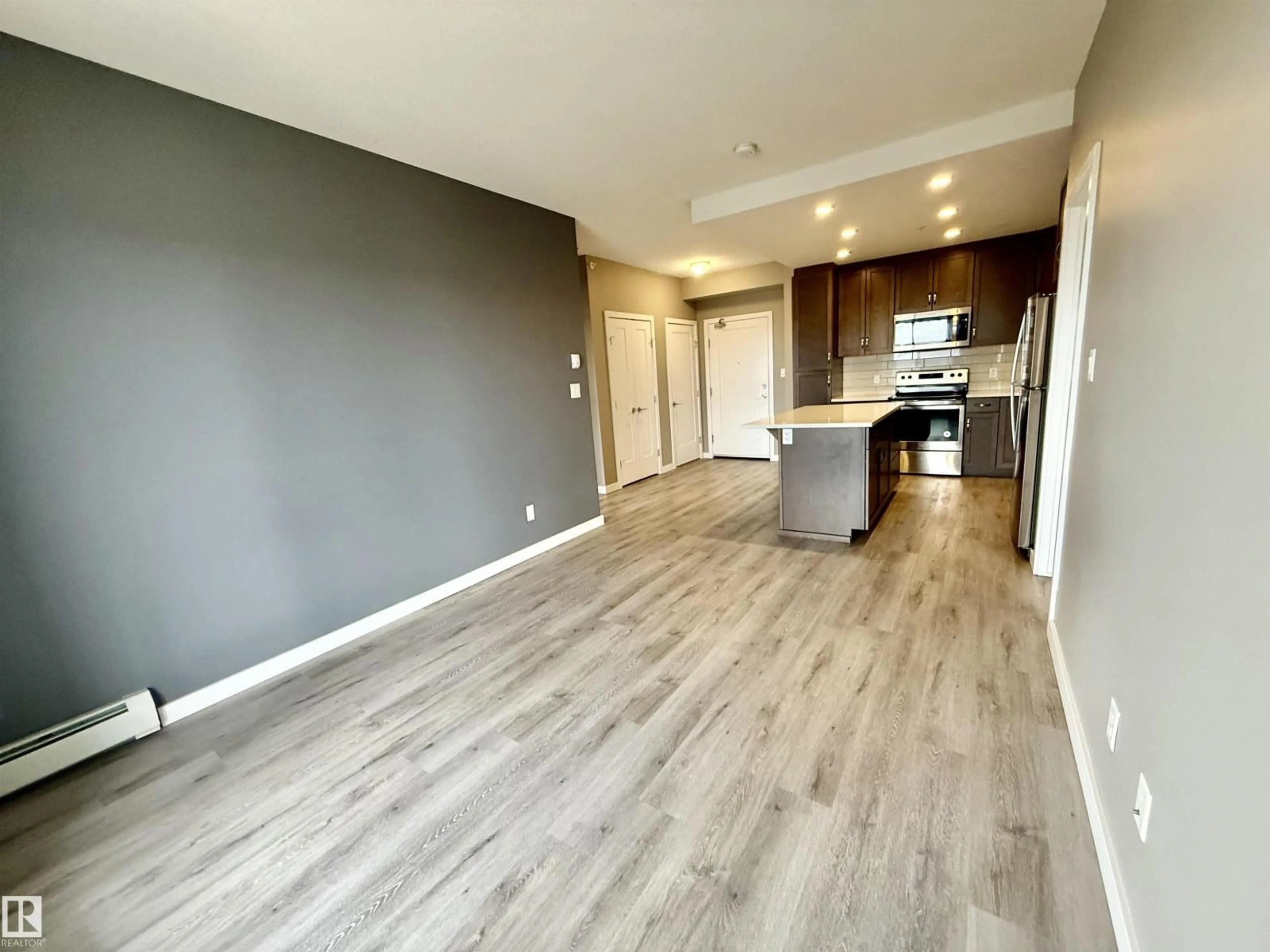 Open concept kitchen, wood/laminate floor for #437 - 5504 SCHONSEE DR, Edmonton Alberta T5Z0N9