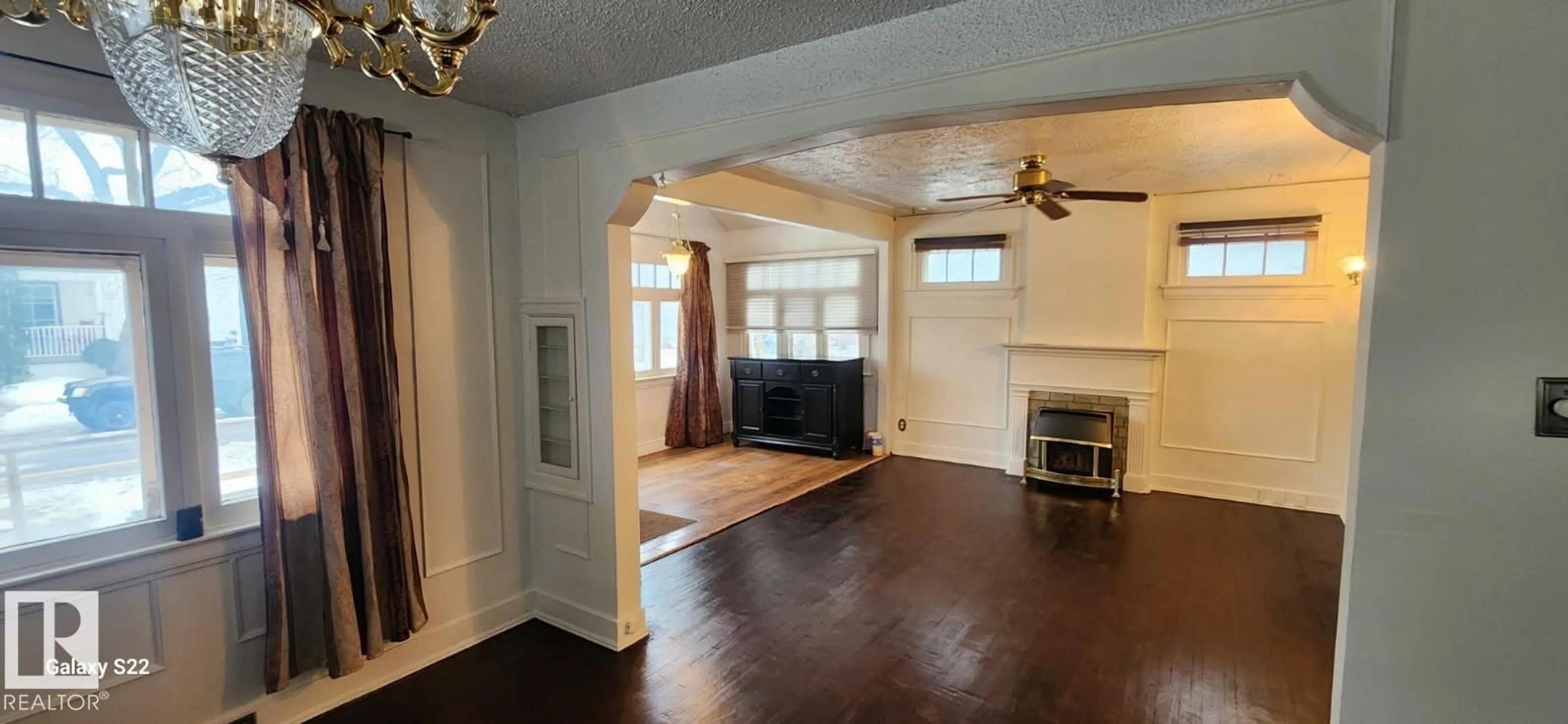 Living room with furniture, wood/laminate floor for 11619 96 ST, Edmonton Alberta T5G1T8