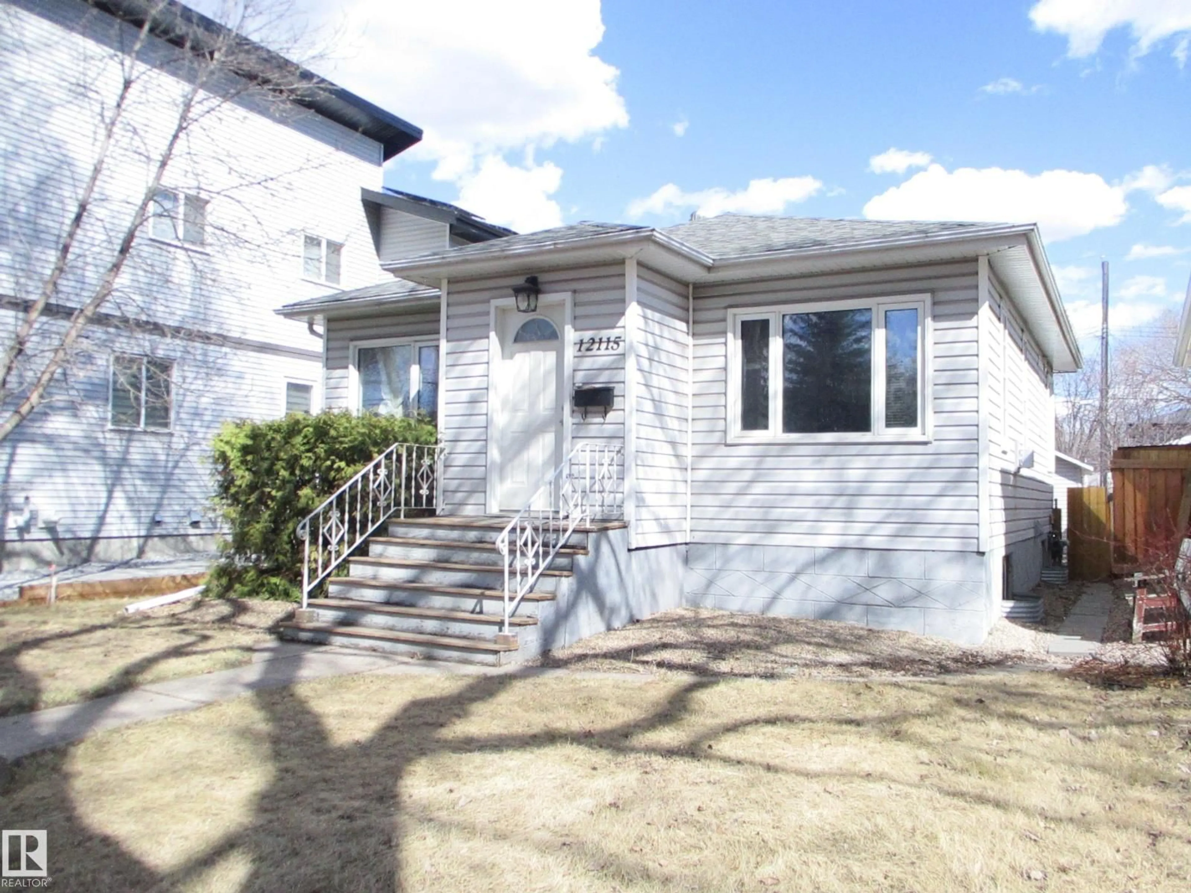 Home with vinyl exterior material, street for 12115 64 ST, Edmonton Alberta T5W4J8