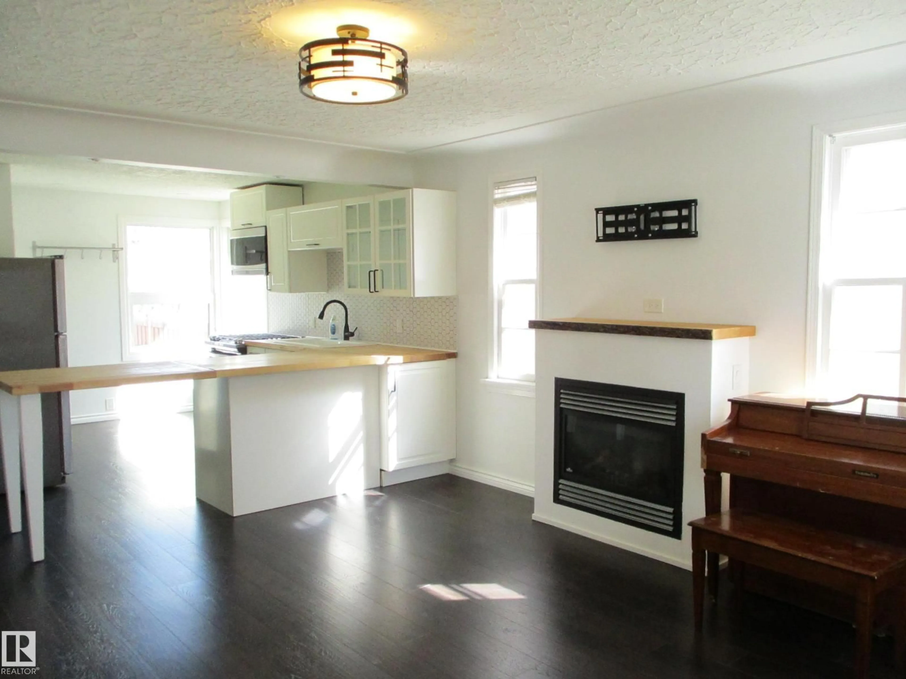 Open concept kitchen, wood/laminate floor for 12115 64 ST, Edmonton Alberta T5W4J8