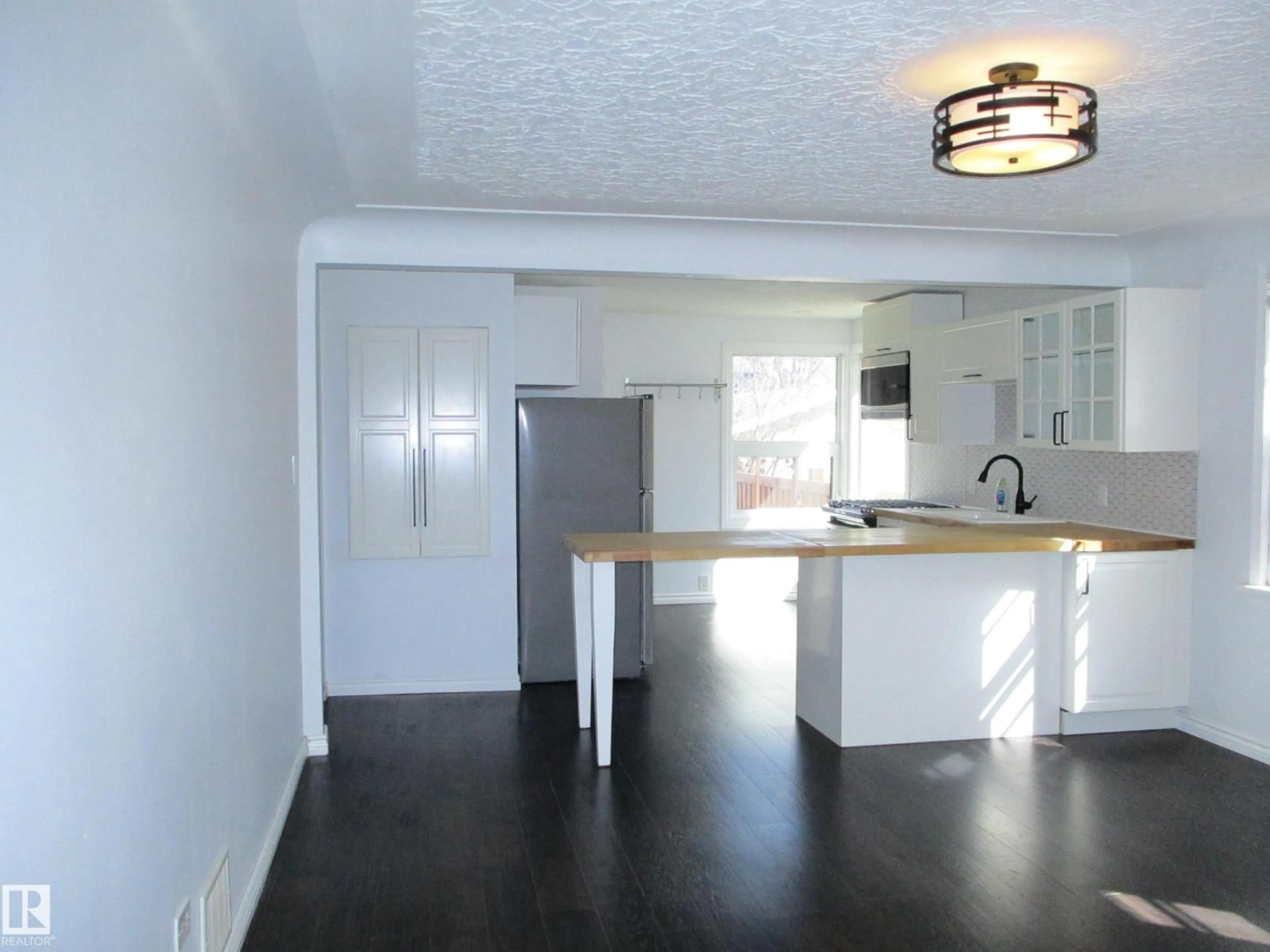 Open concept kitchen, wood/laminate floor for 12115 64 ST, Edmonton Alberta T5W4J8