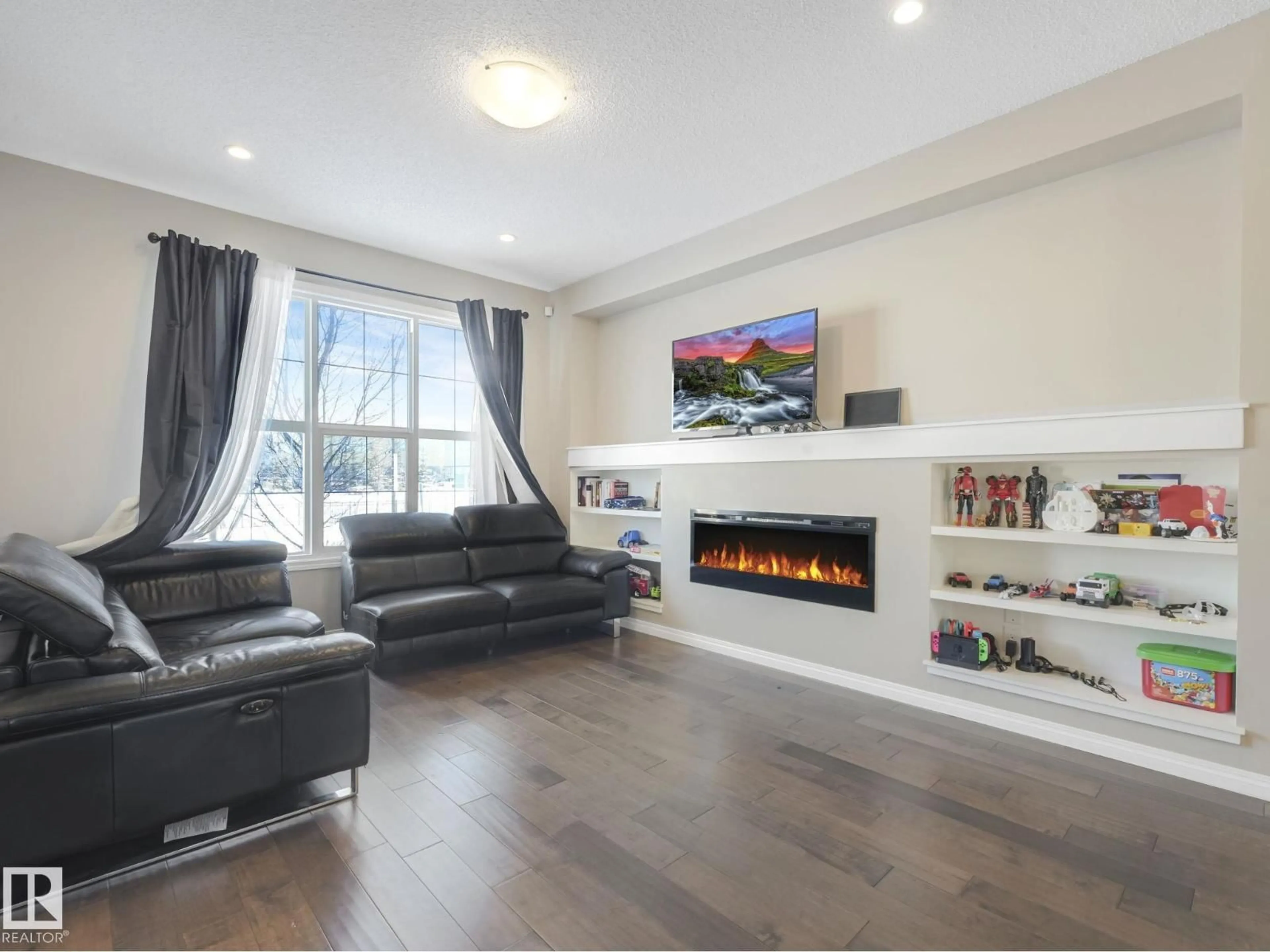 Living room with furniture, wood/laminate floor for 8119 CHAPPELLE WY, Edmonton Alberta T6W3L7