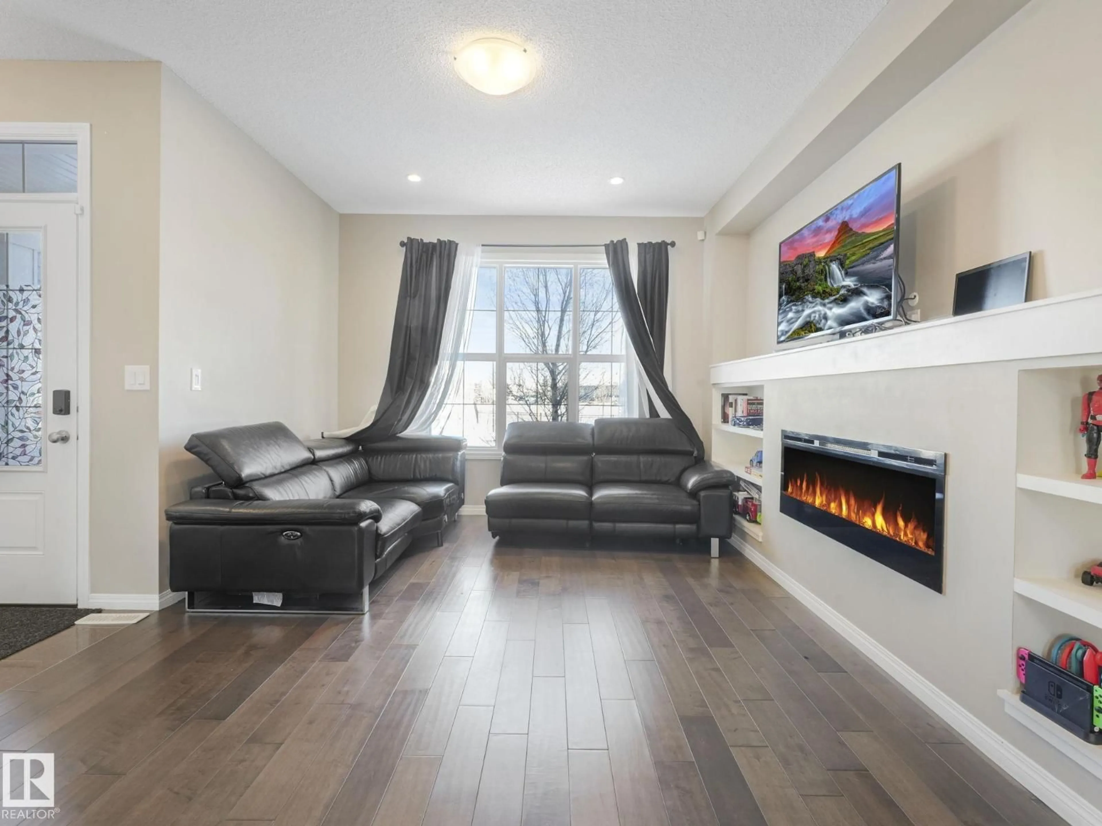 Living room with furniture, wood/laminate floor for 8119 CHAPPELLE WY, Edmonton Alberta T6W3L7