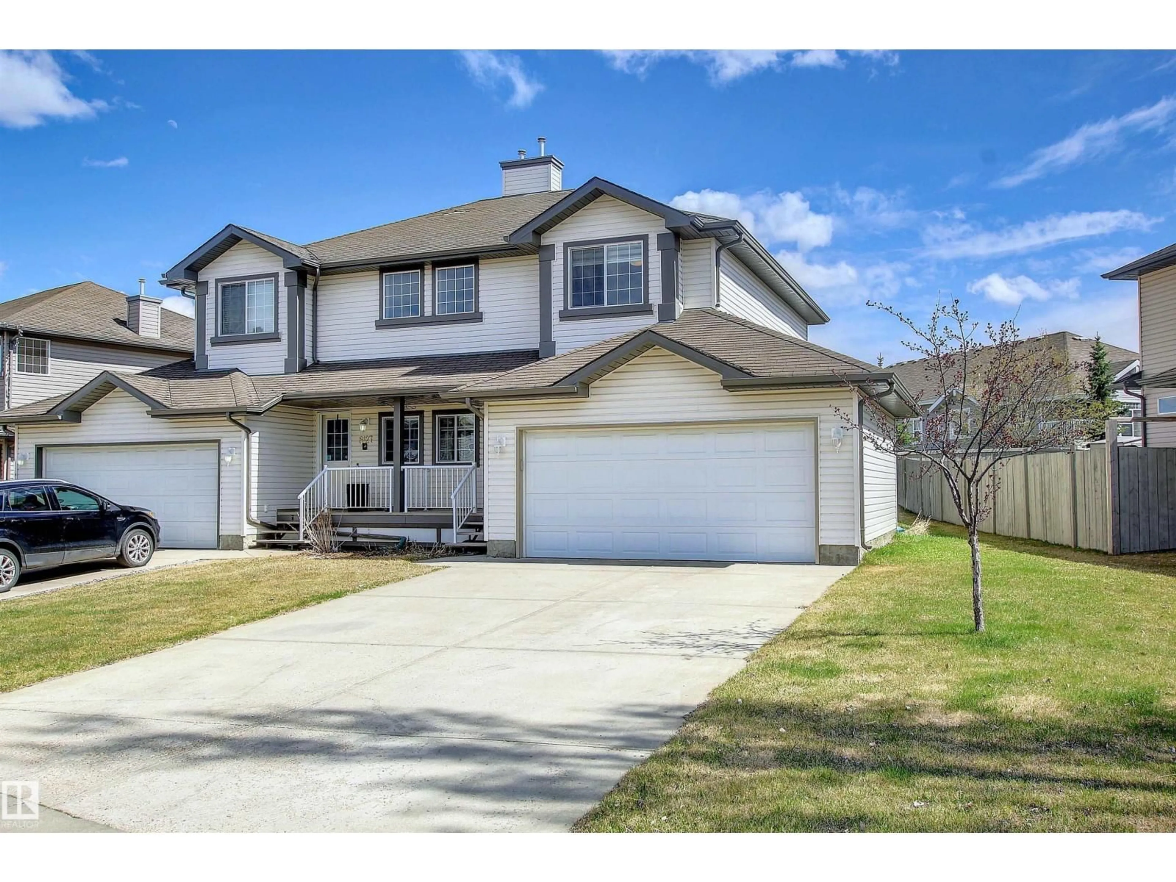 Home with vinyl exterior material, street for 8129 7 AV SW, Edmonton Alberta T6X1L9