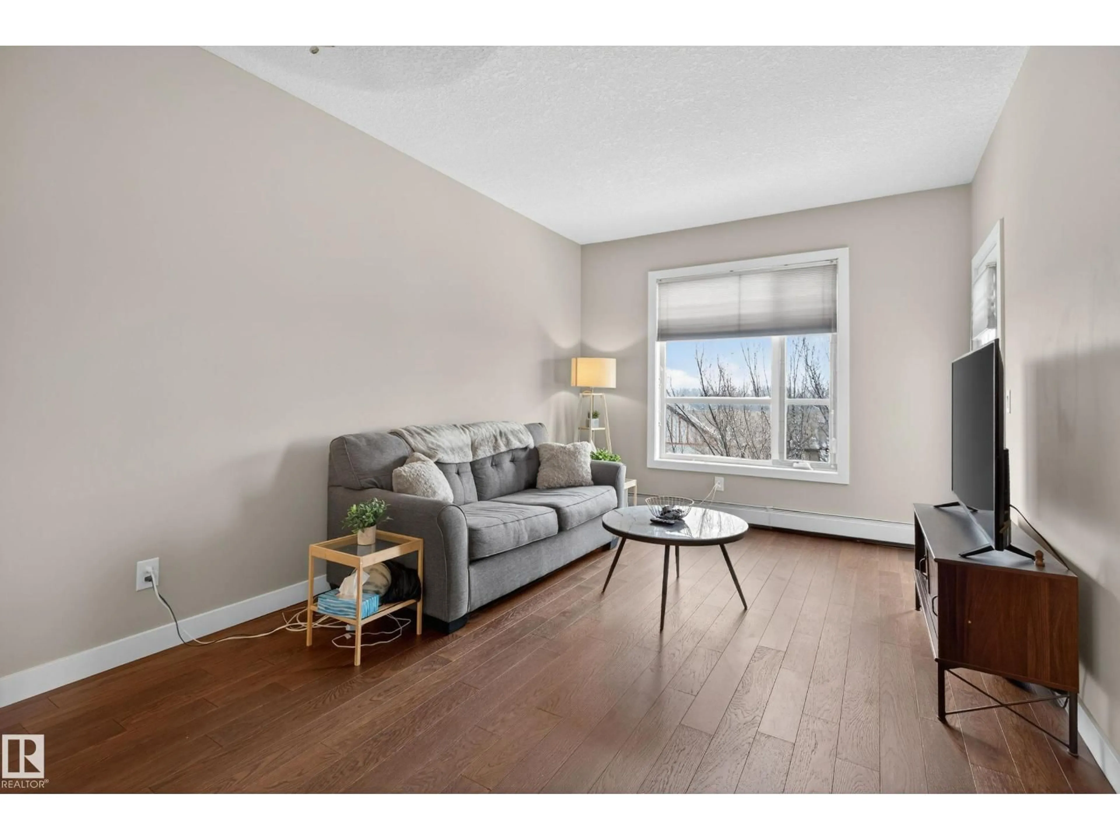 Living room with furniture, wood/laminate floor for #409 - 2584 ANDERSON WY, Edmonton Alberta T6W0R2