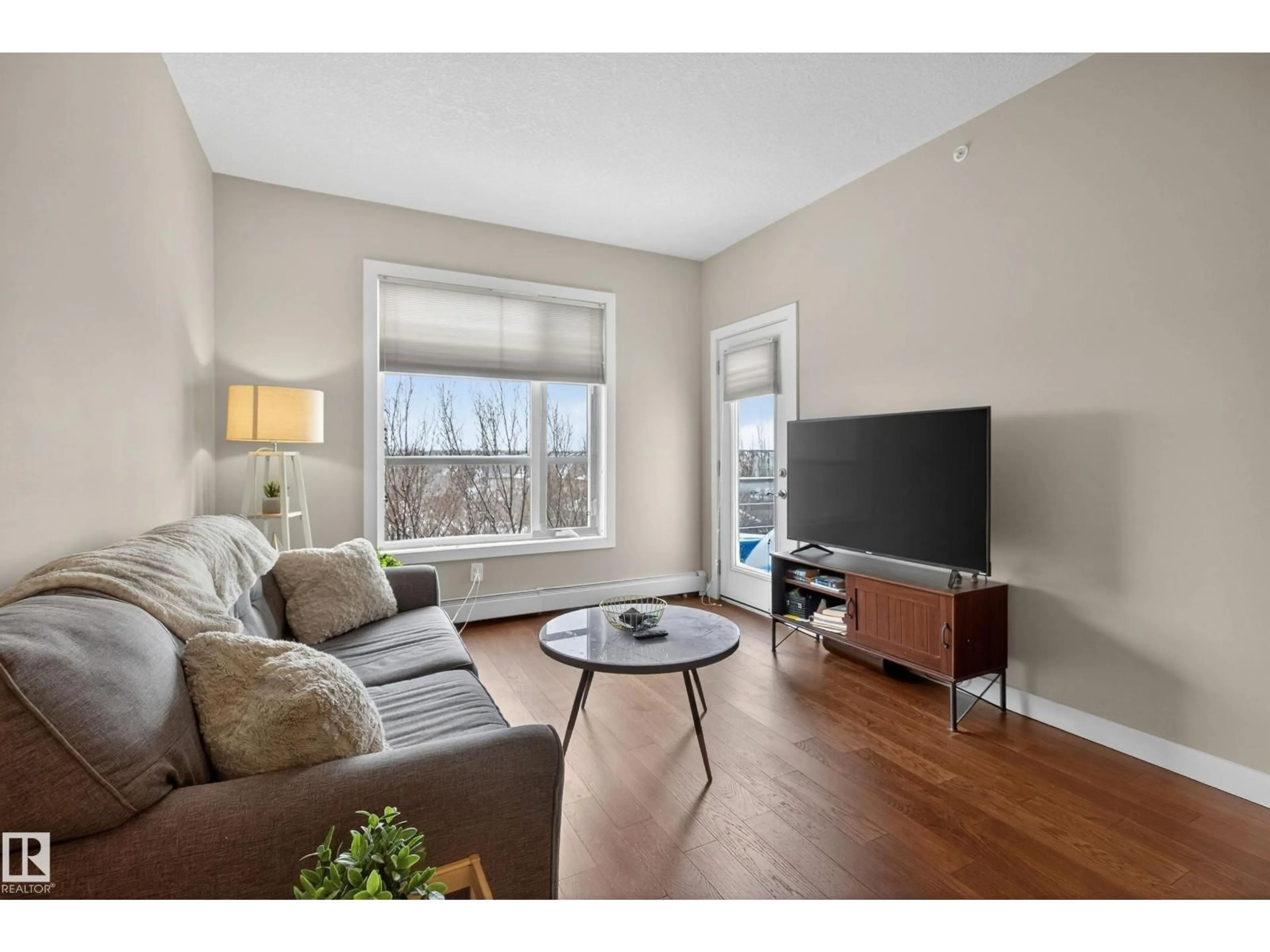 Living room with furniture, wood/laminate floor for #409 - 2584 ANDERSON WY, Edmonton Alberta T6W0R2