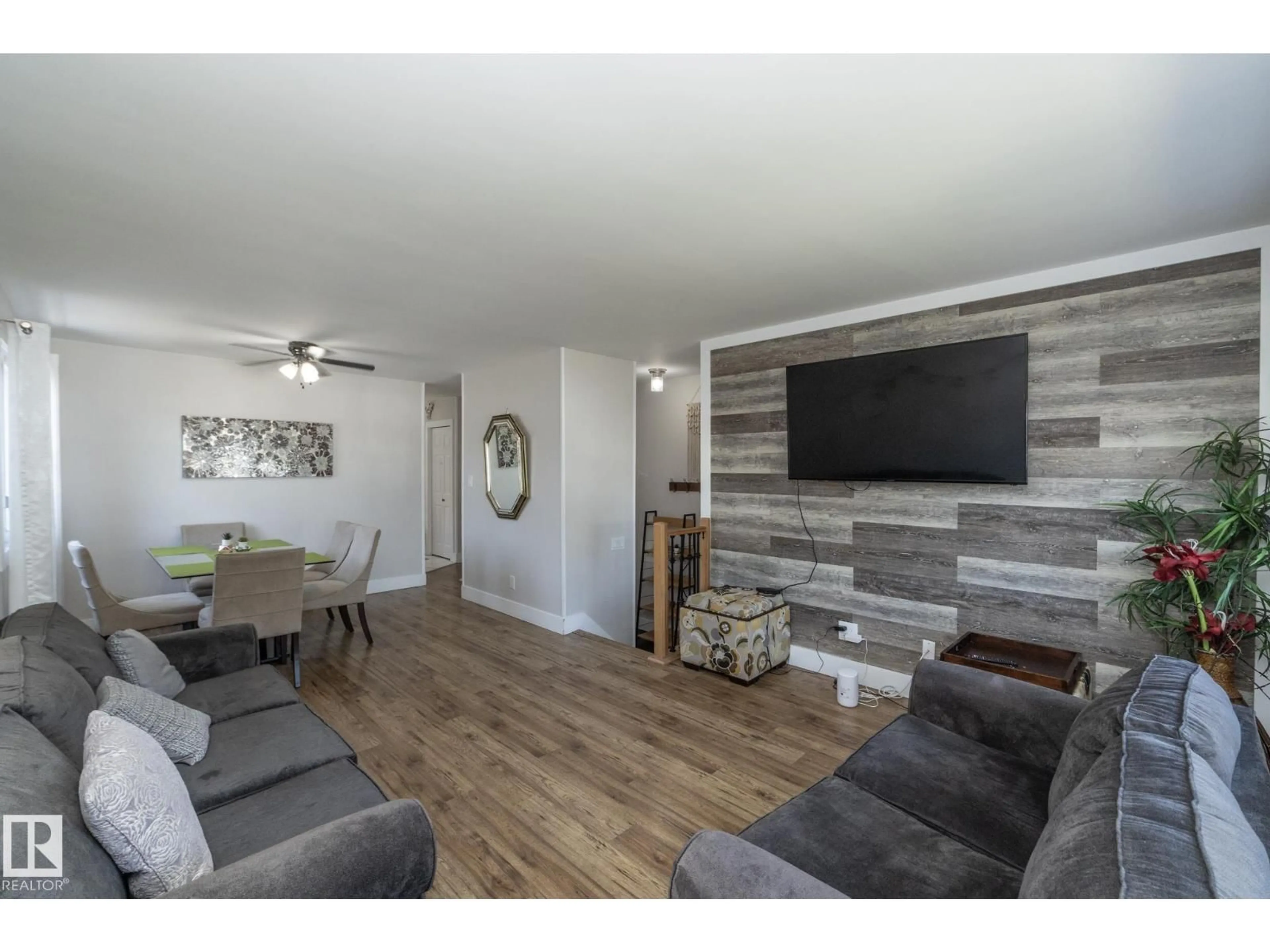 Living room with furniture, wood/laminate floor for NW - 3511 33 AV, Edmonton Alberta T6L4N6