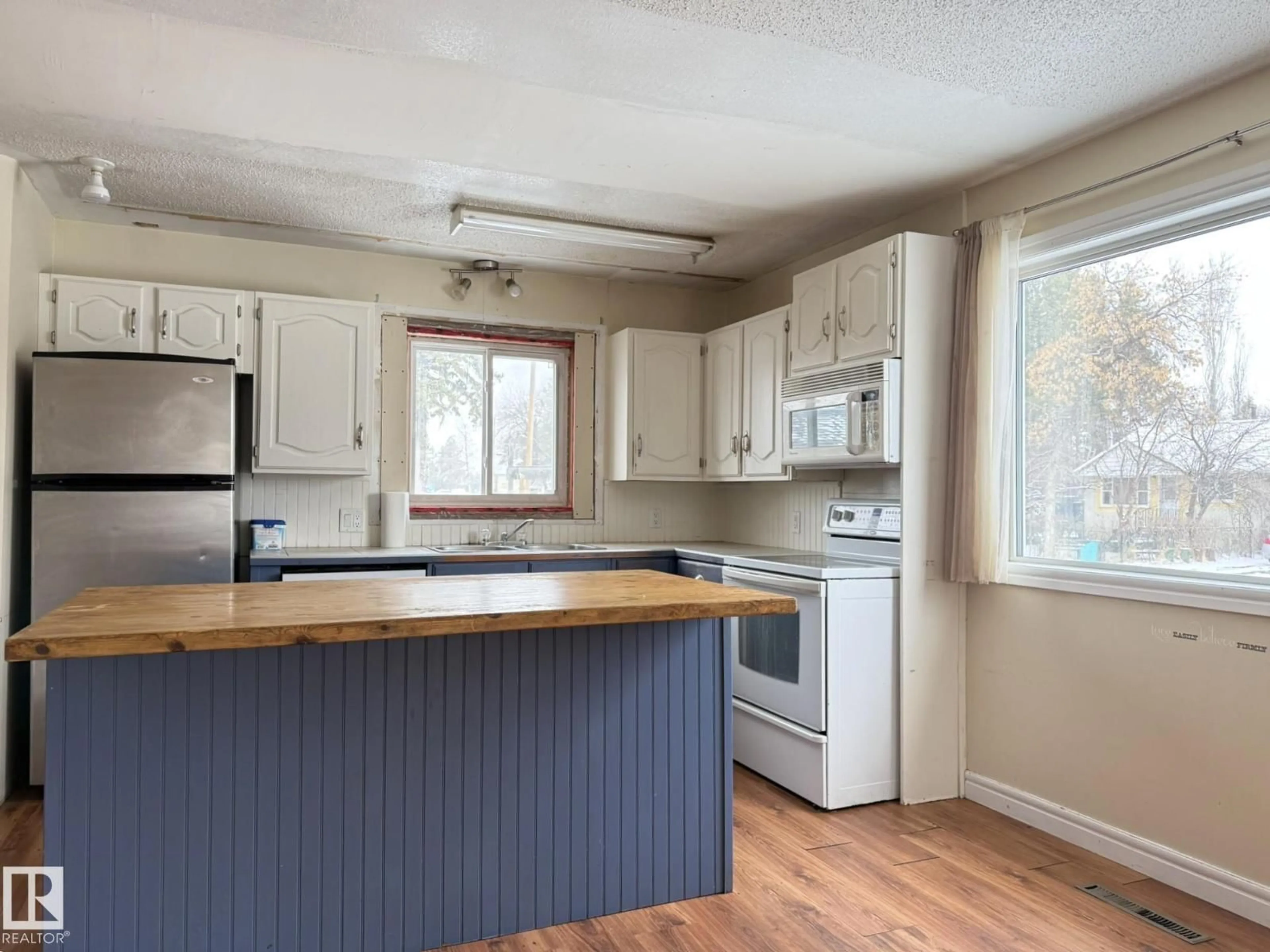 Open concept kitchen, wood/laminate floor for 5116 48 ST, Warburg Alberta T0C2T0