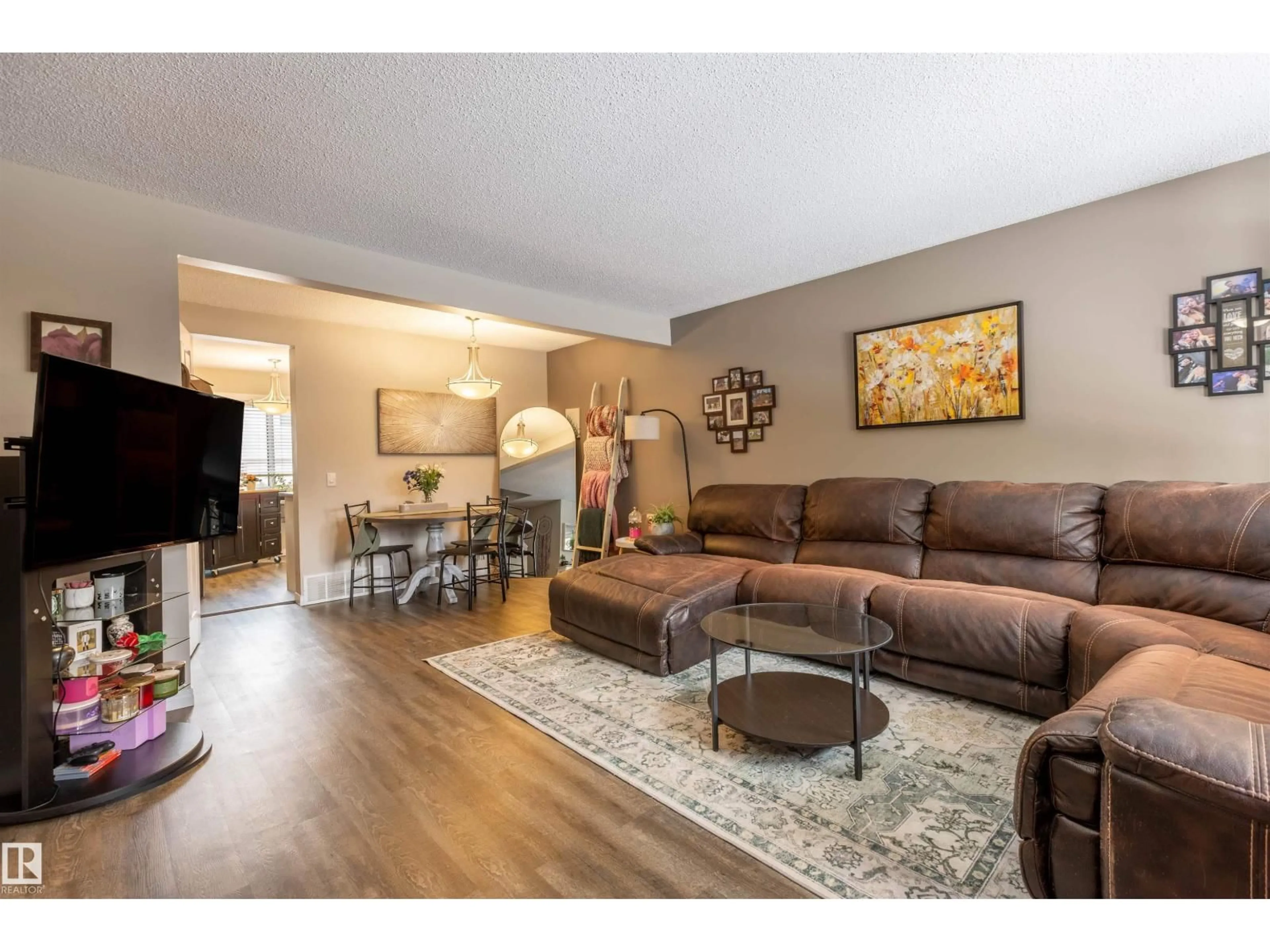 Living room with furniture, wood/laminate floor for 15 WALDEN, St. Albert Alberta T8N3V6