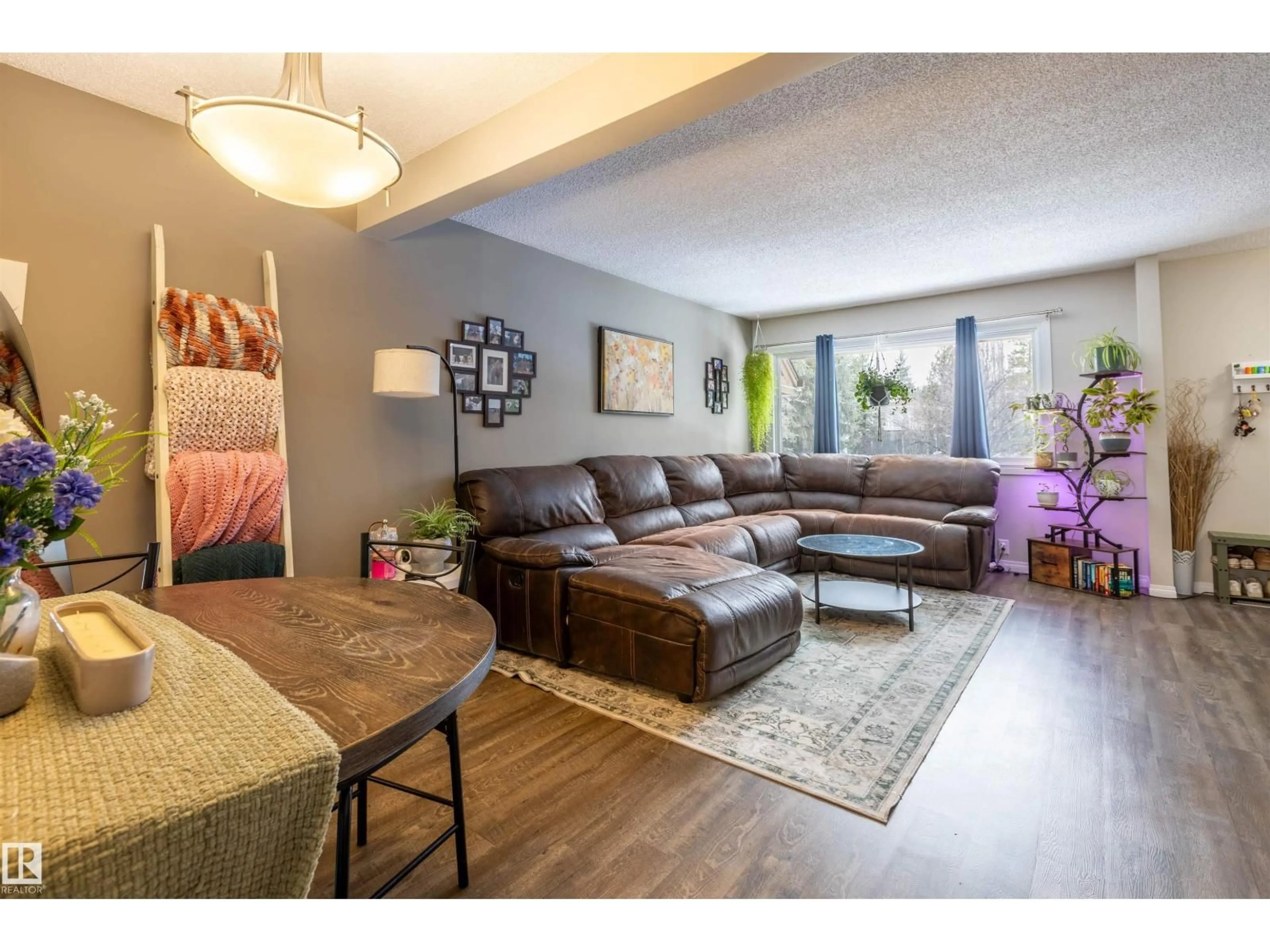 Living room with furniture, wood/laminate floor for 15 WALDEN, St. Albert Alberta T8N3V6