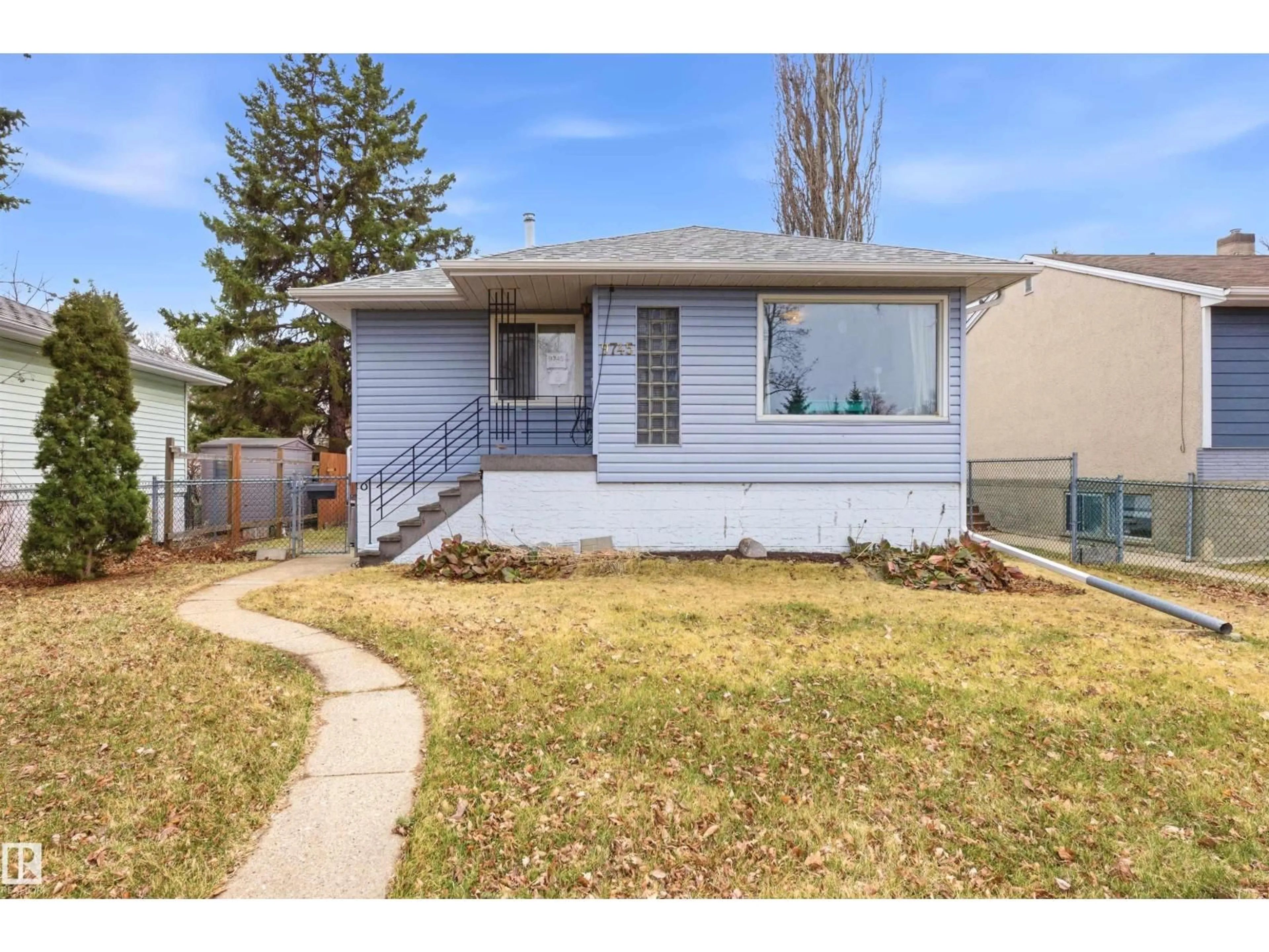Home with vinyl exterior material, street for 9745 68 AV, Edmonton Alberta T6E0R3