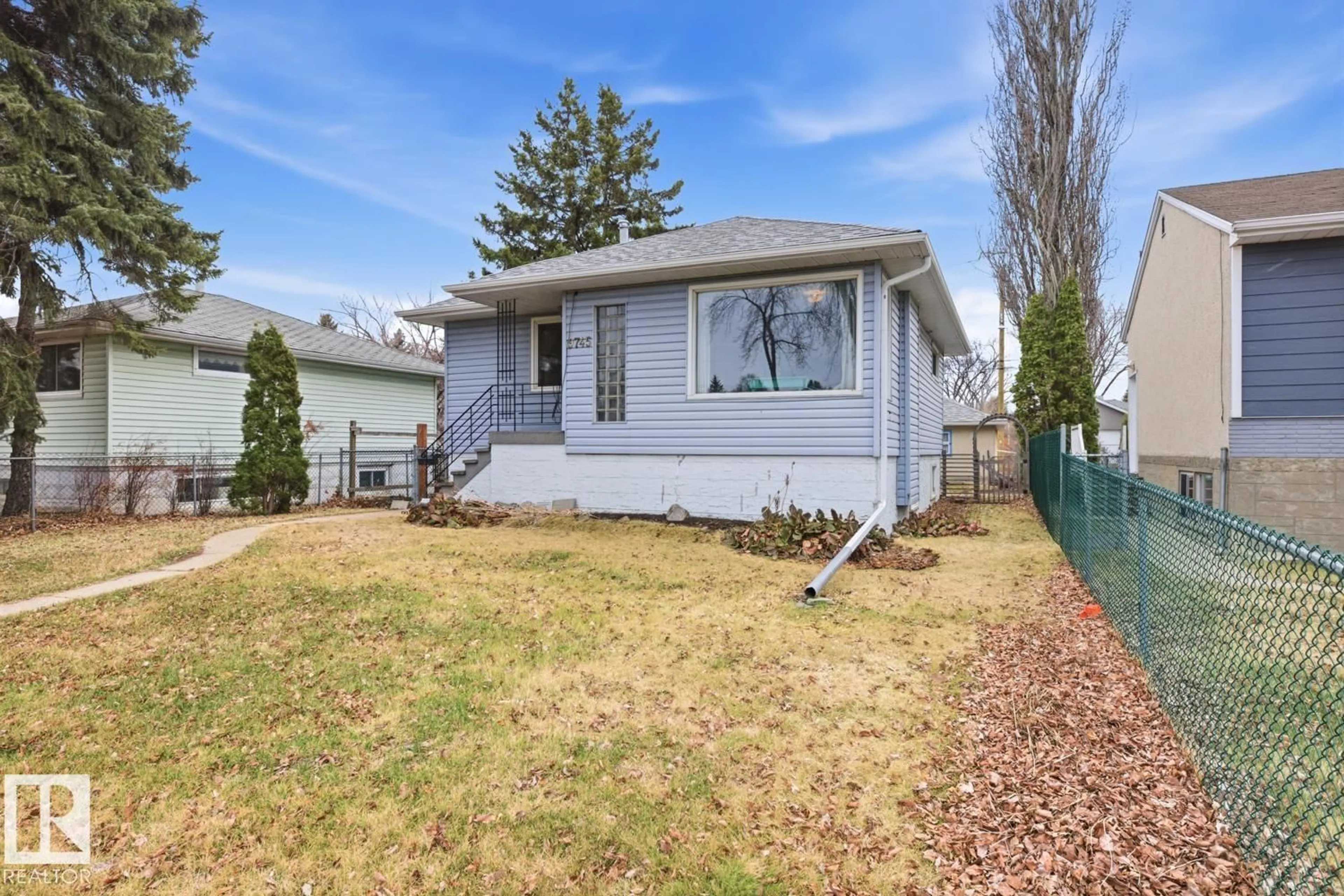 Home with vinyl exterior material, street for 9745 68 AV, Edmonton Alberta T6E0R3