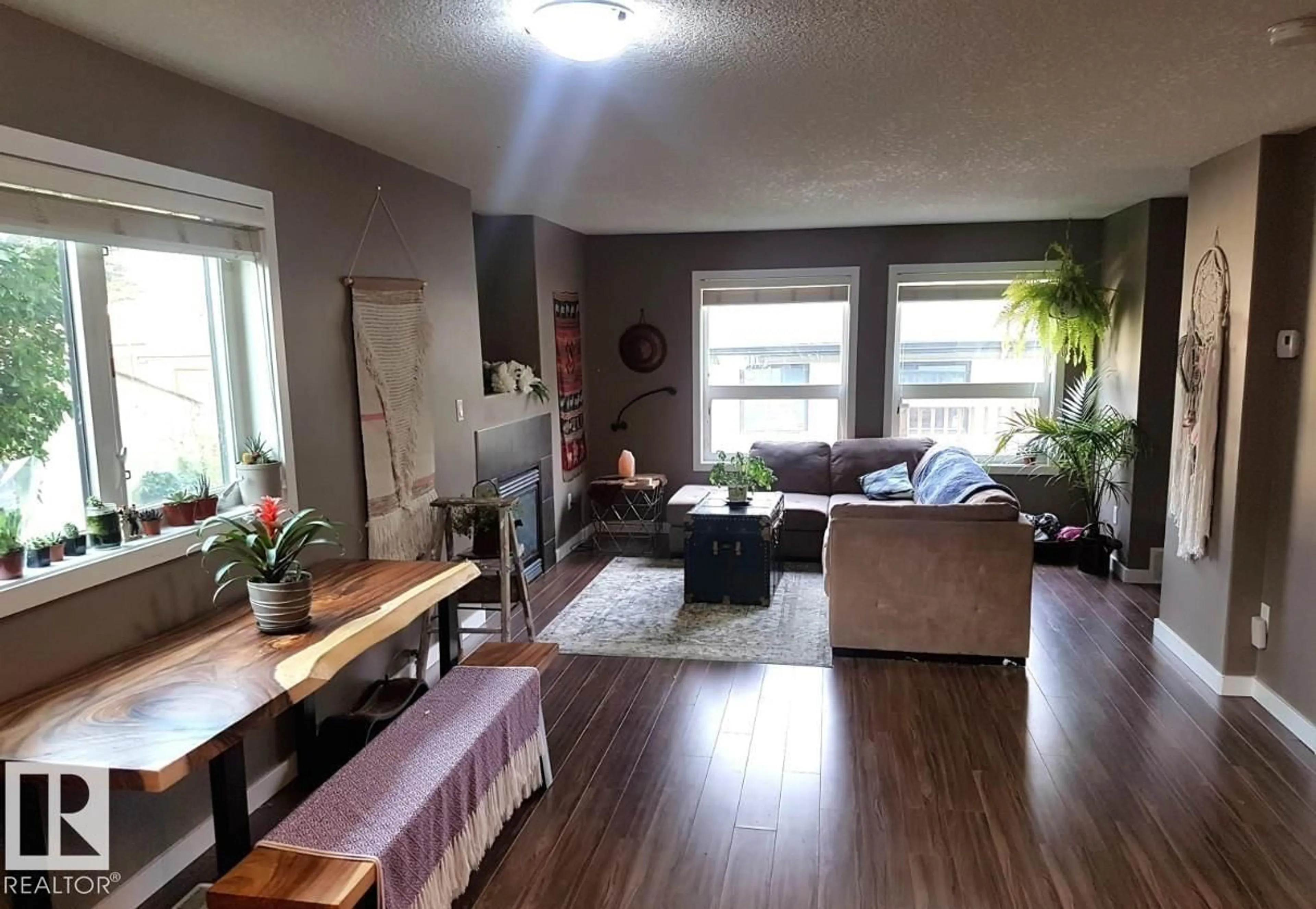 Living room with furniture, wood/laminate floor for NW - 12246 103 ST, Edmonton Alberta T5G2K1