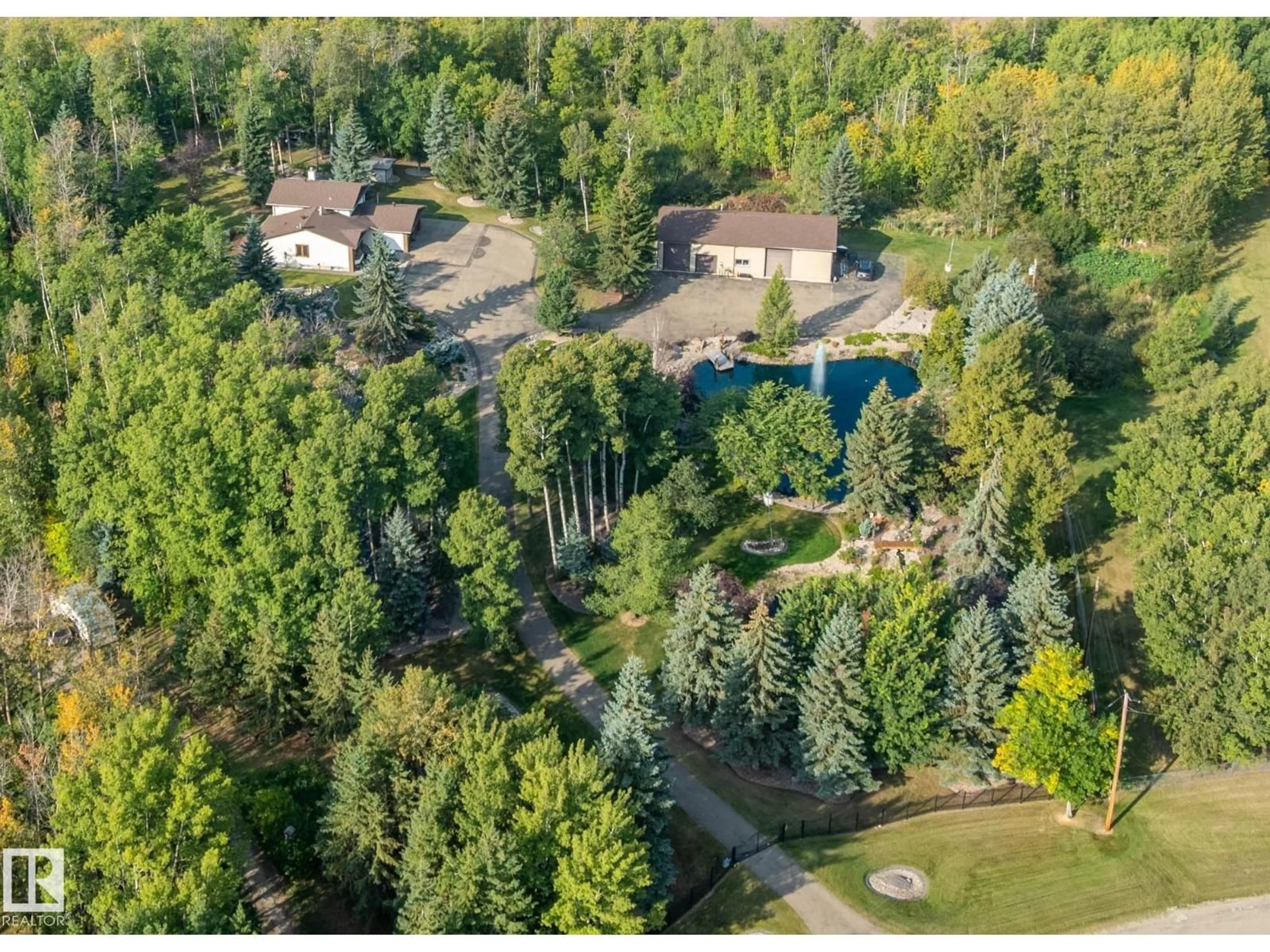 A pic from outside/outdoor area/front of a property/back of a property/a pic from drone, forest/trees view for 170 - 50470 RANGE ROAD 234, Rural Leduc County Alberta T4X0L7