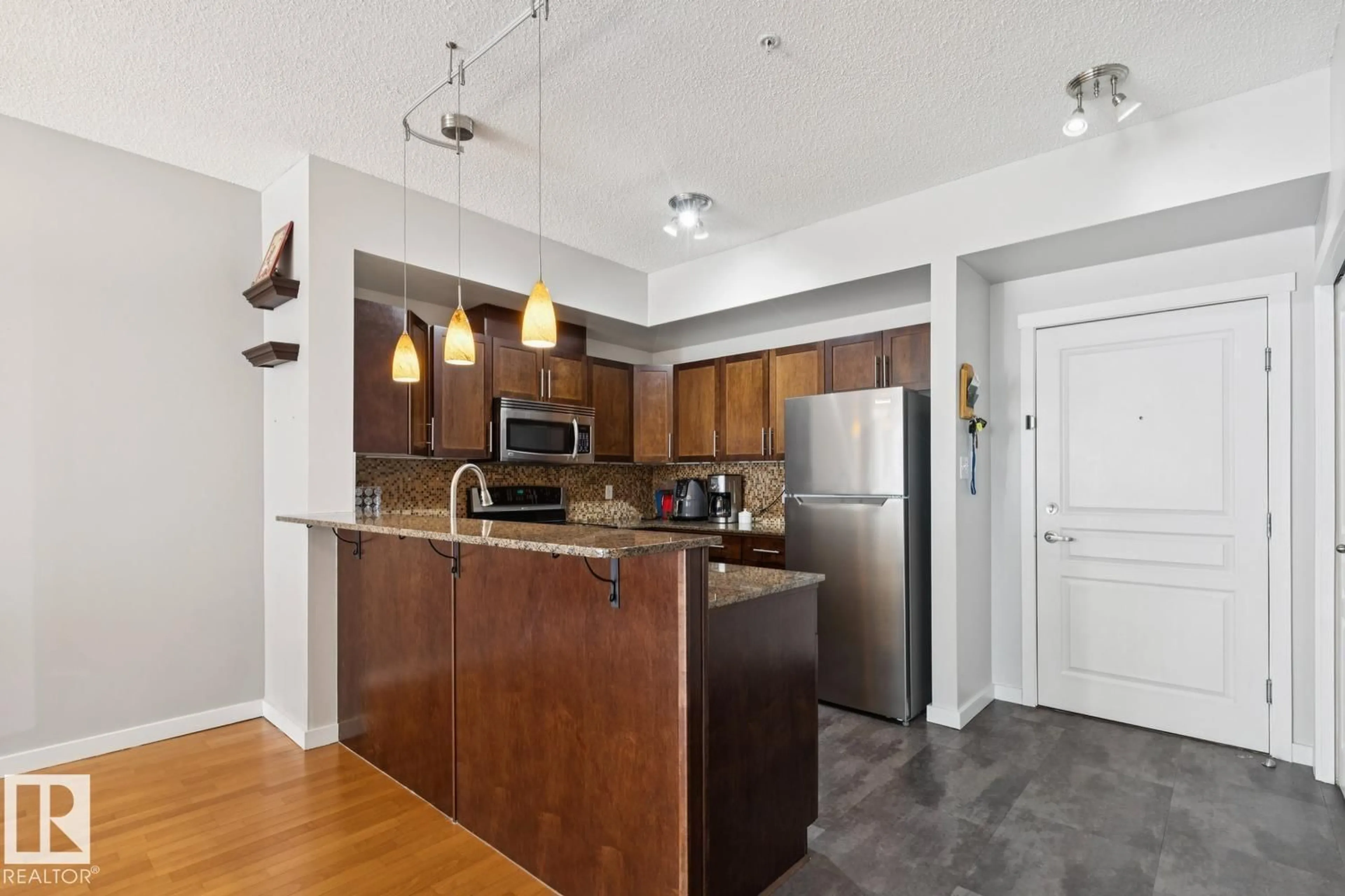 Open concept kitchen, wood/laminate floor for #101 - 11140 68 AV, Edmonton Alberta T6H2C2