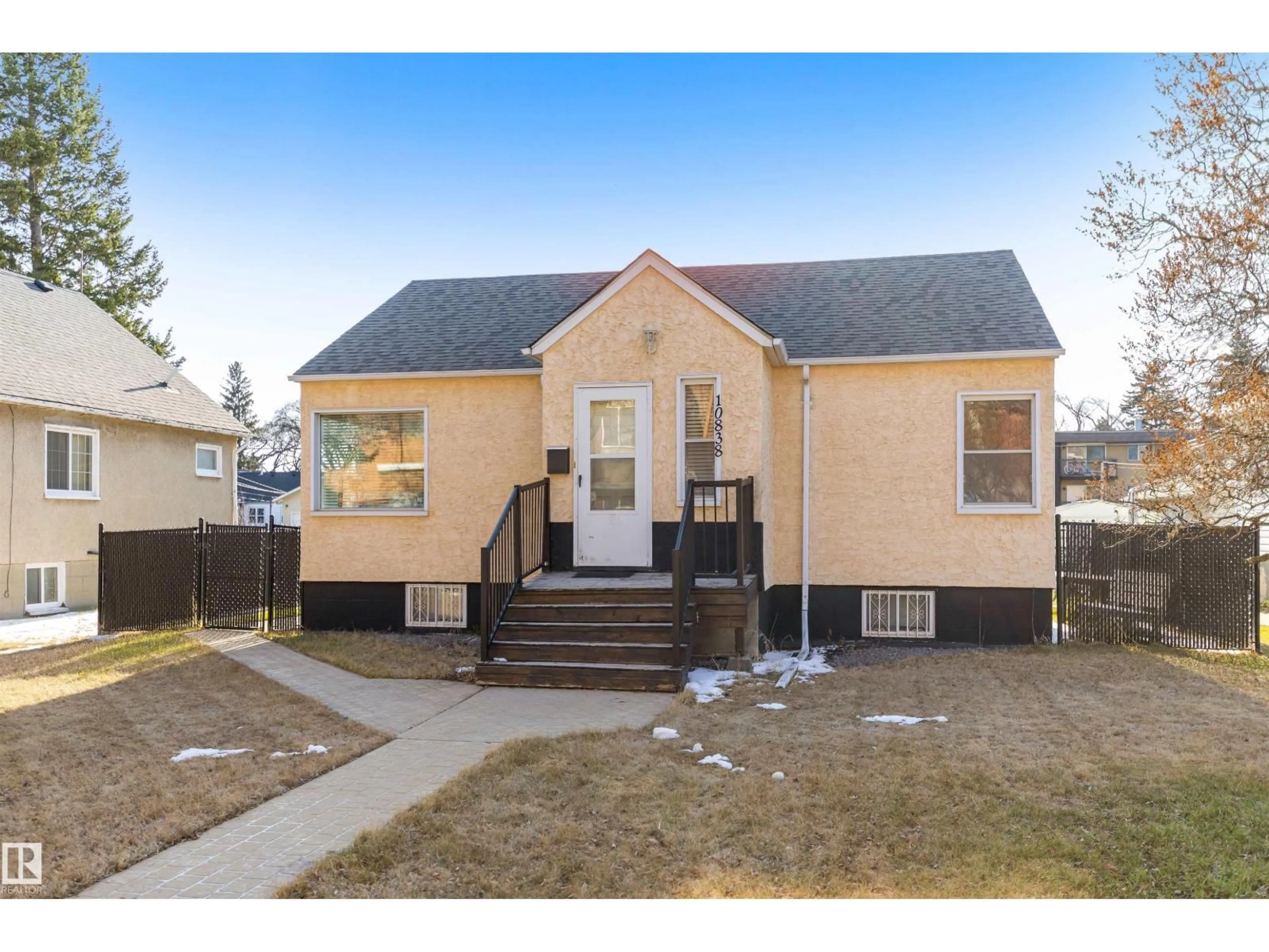 Home with vinyl exterior material, street for 10838 110 ST NW, Edmonton Alberta T5H3E2