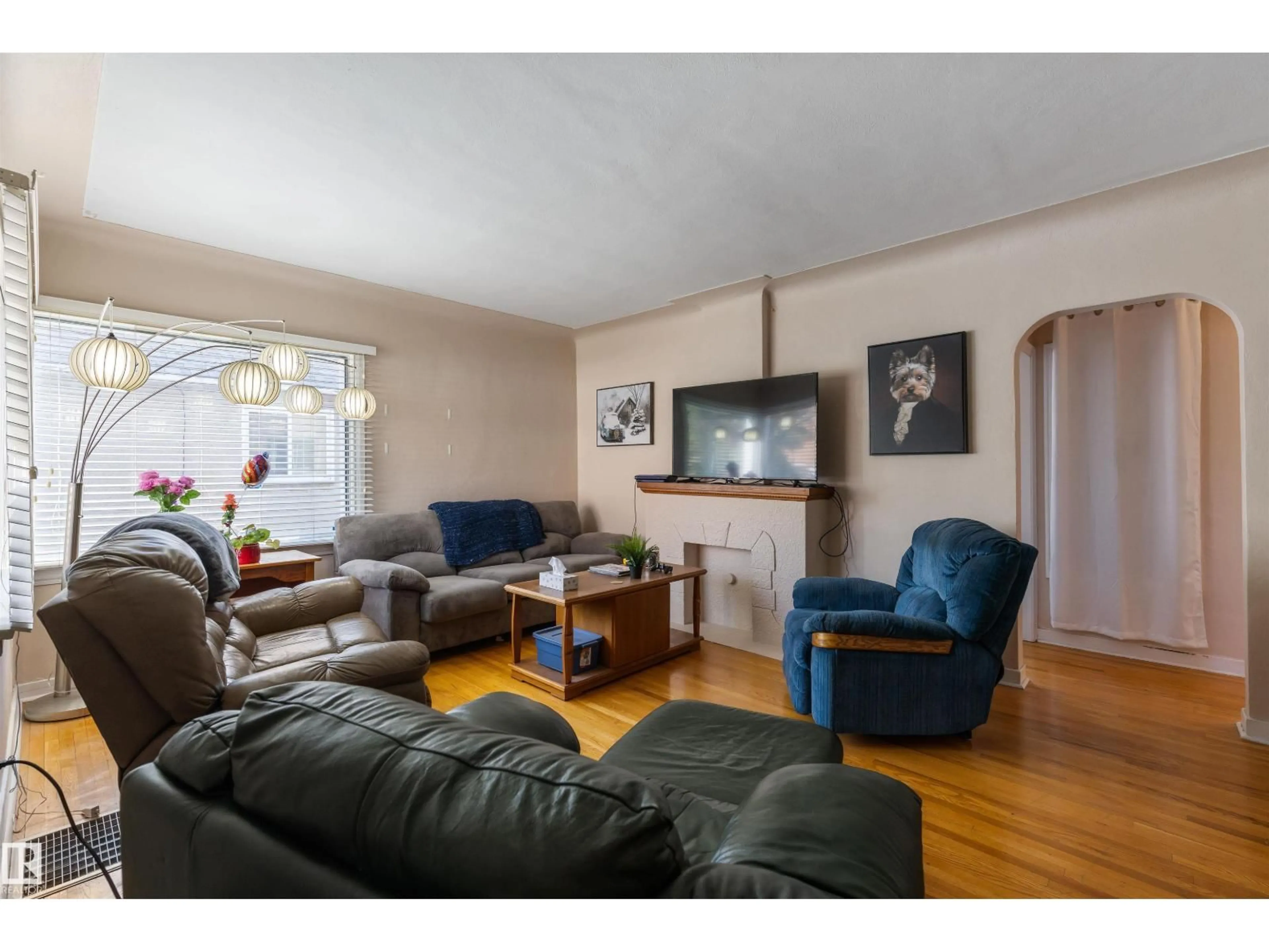 Living room with furniture, wood/laminate floor for 10838 110 ST NW, Edmonton Alberta T5H3E2