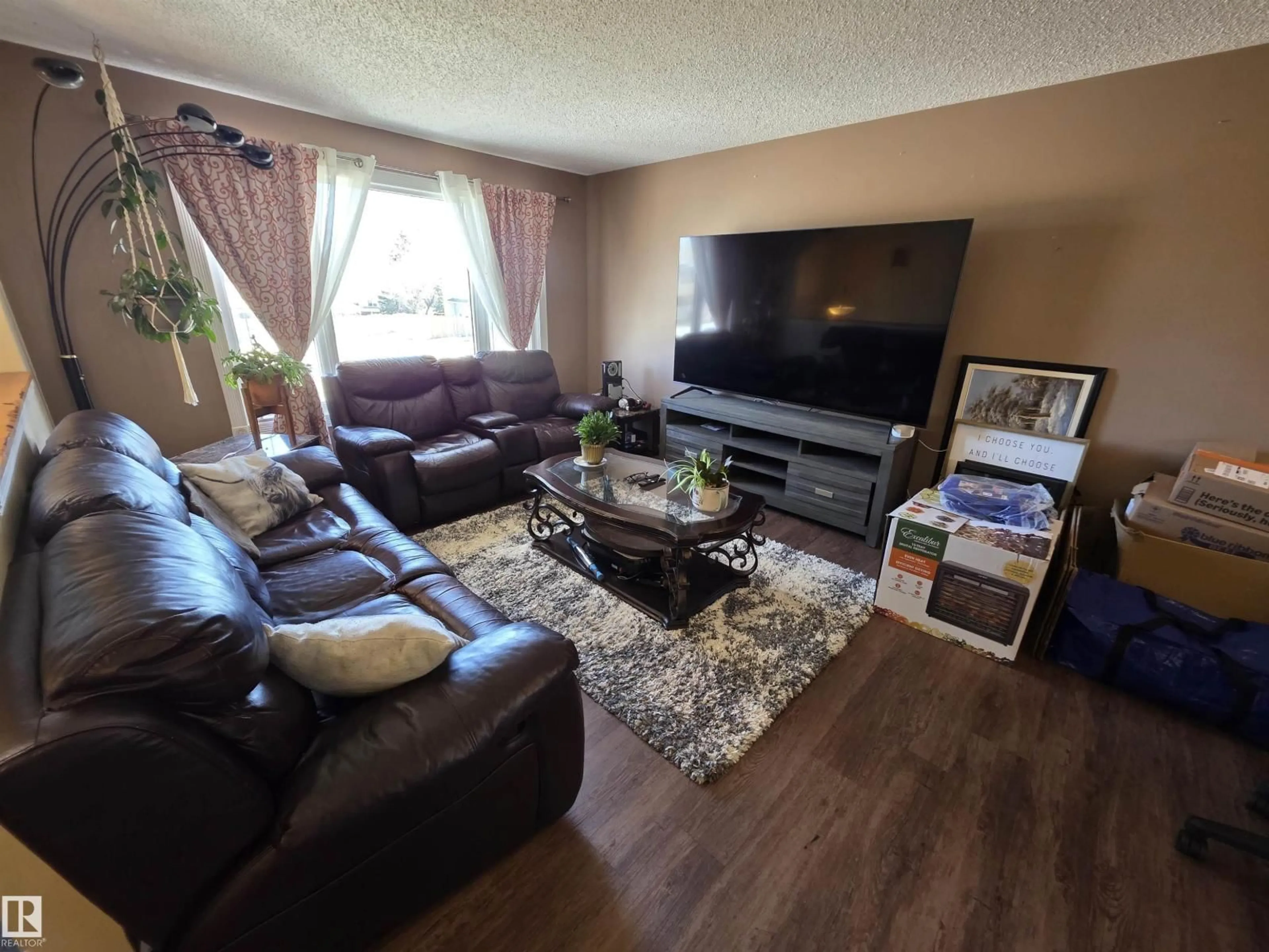 Living room with furniture, wood/laminate floor for 4804 BECKETT RD, Drayton Valley Alberta T7A1C7