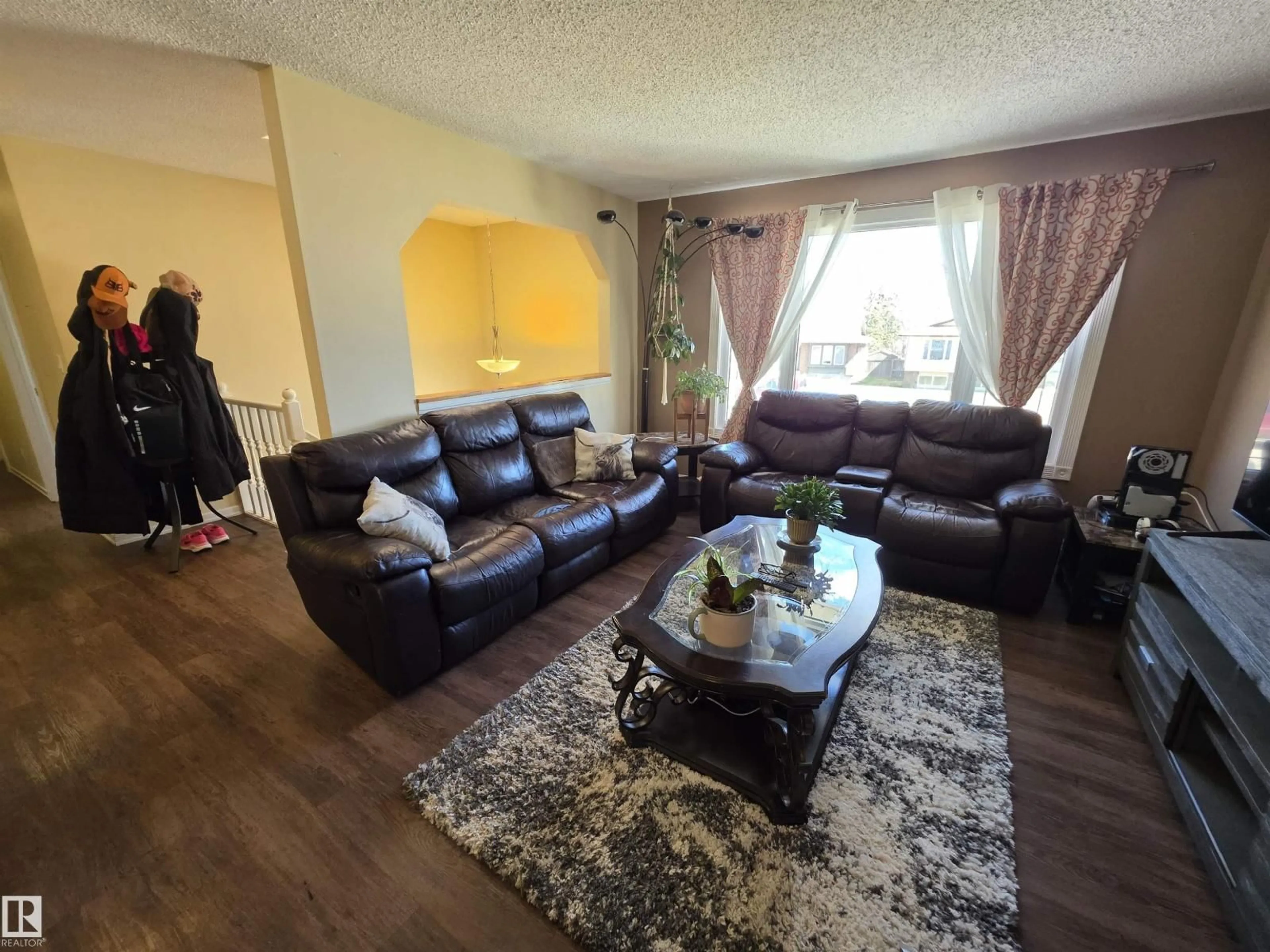 Living room with furniture, wood/laminate floor for 4804 BECKETT RD, Drayton Valley Alberta T7A1C7