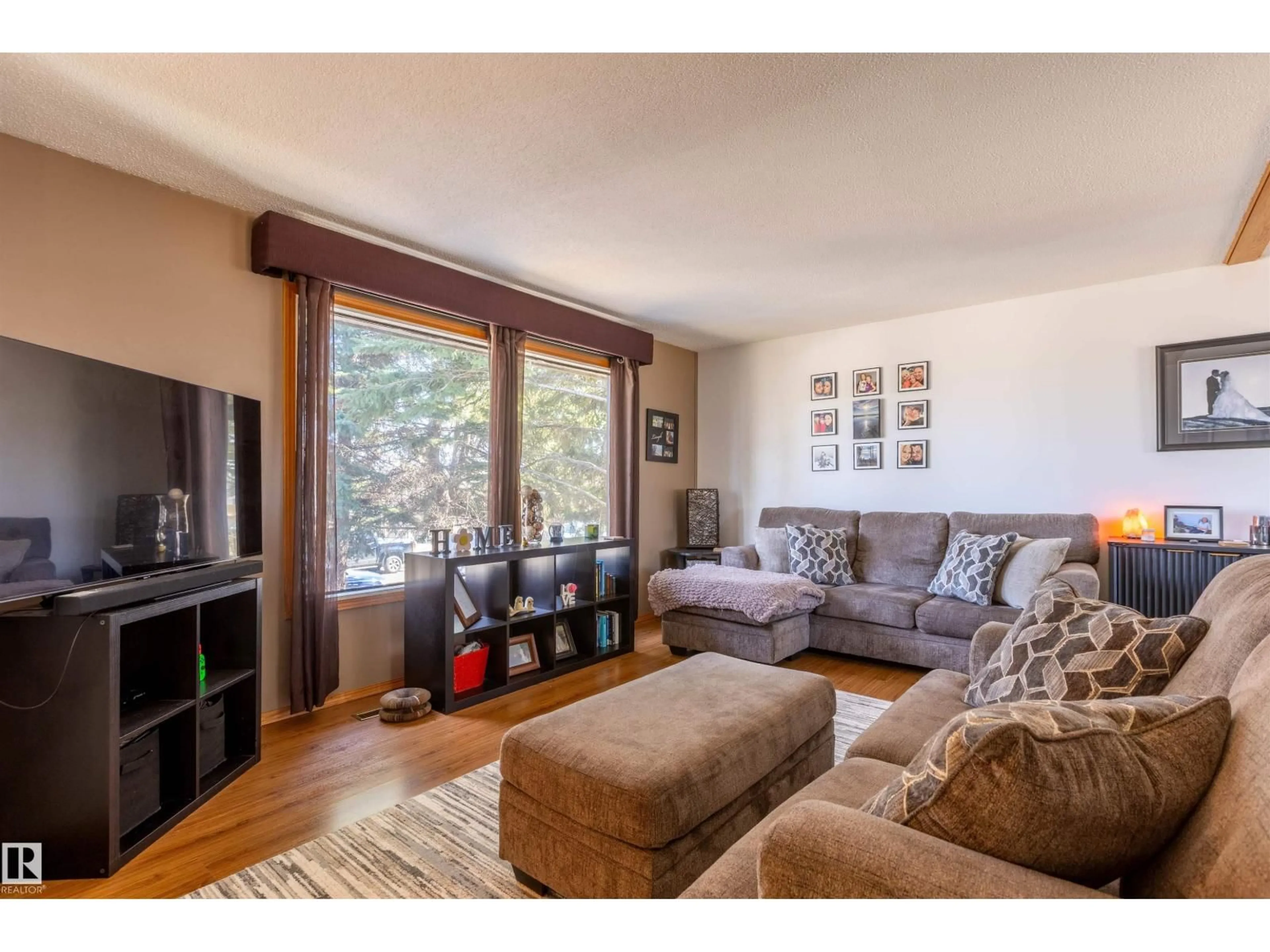 Living room with furniture, wood/laminate floor for 4824 51 ST, Legal Alberta T0G1L0