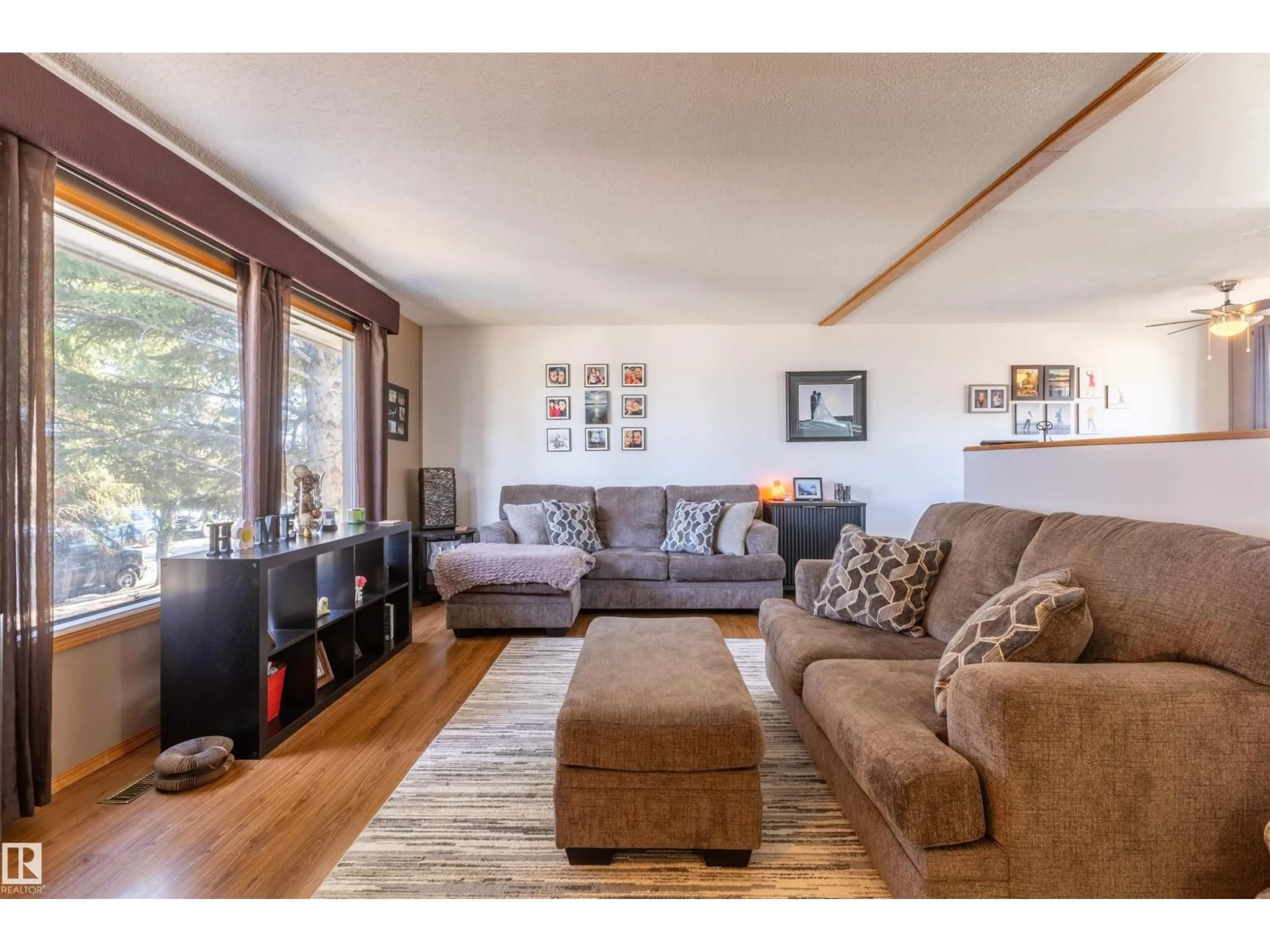 Living room with furniture, wood/laminate floor for 4824 51 ST, Legal Alberta T0G1L0