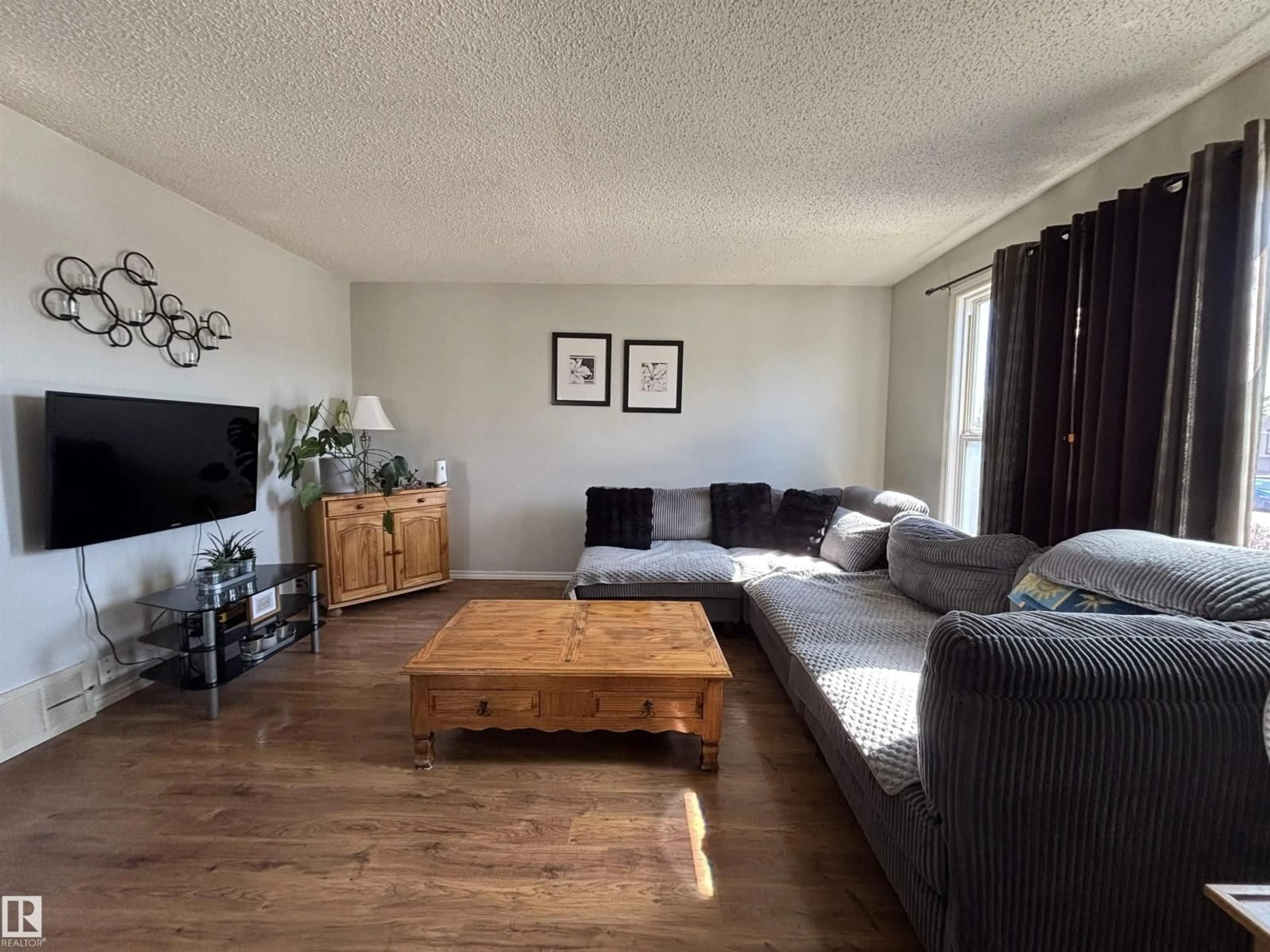 Living room with furniture, wood/laminate floor for 104 BIRCH DR, Gibbons Alberta T0A1N0
