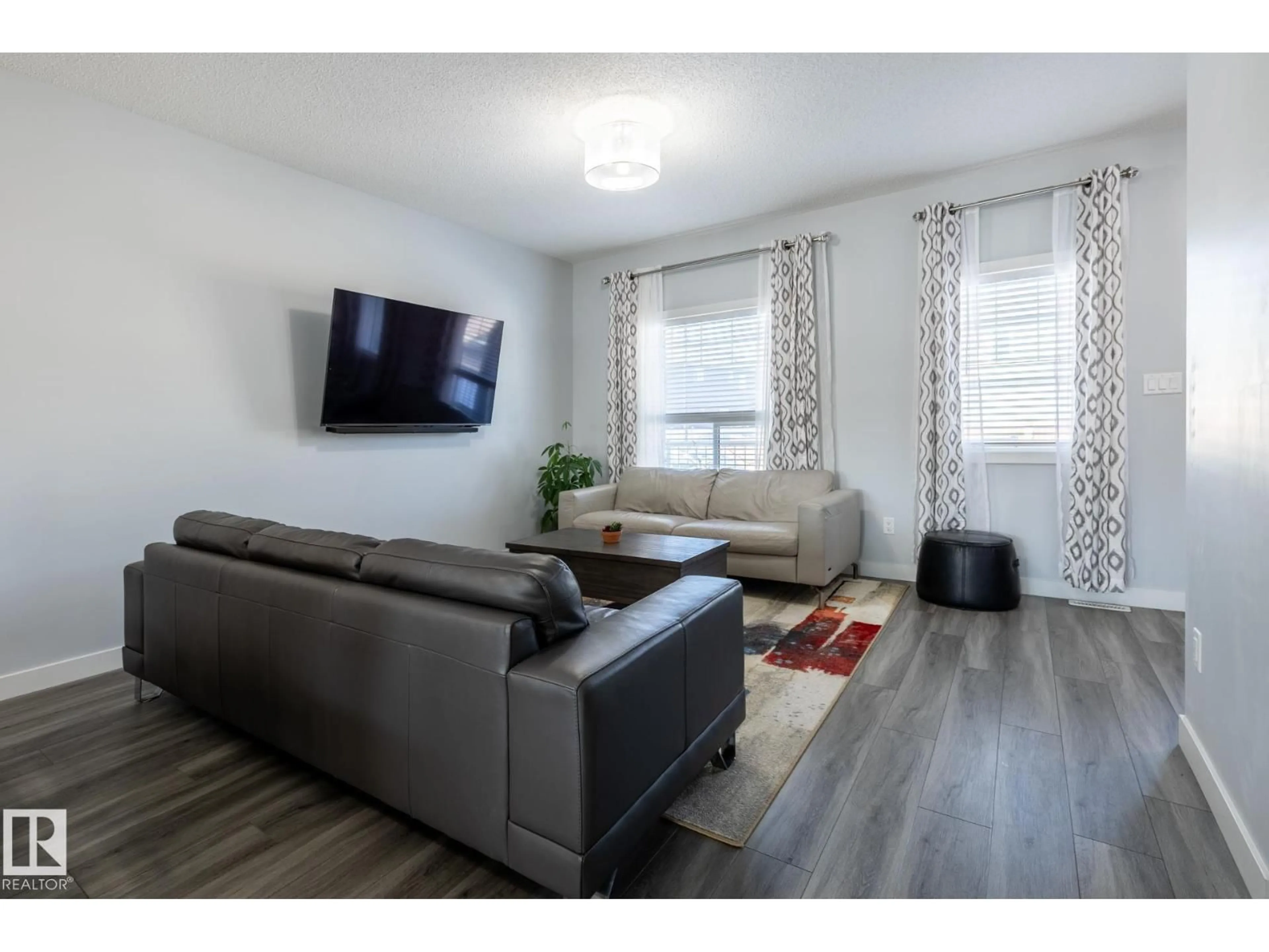 Living room with furniture, wood/laminate floor for NW - 17721 64A ST, Edmonton Alberta T5Y3X4