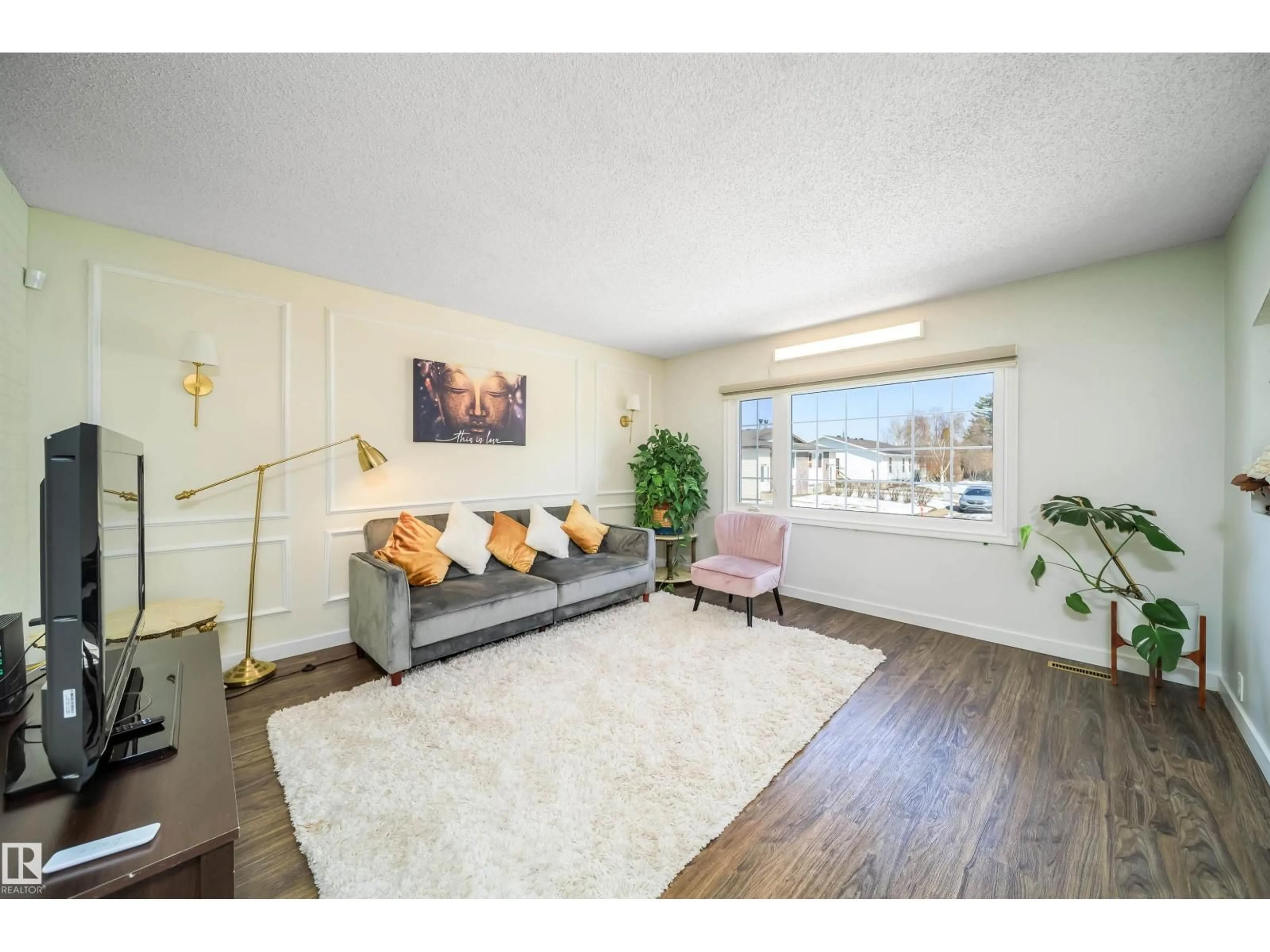 Living room with furniture, wood/laminate floor for 5303 21 AV, Edmonton Alberta T6L5G5