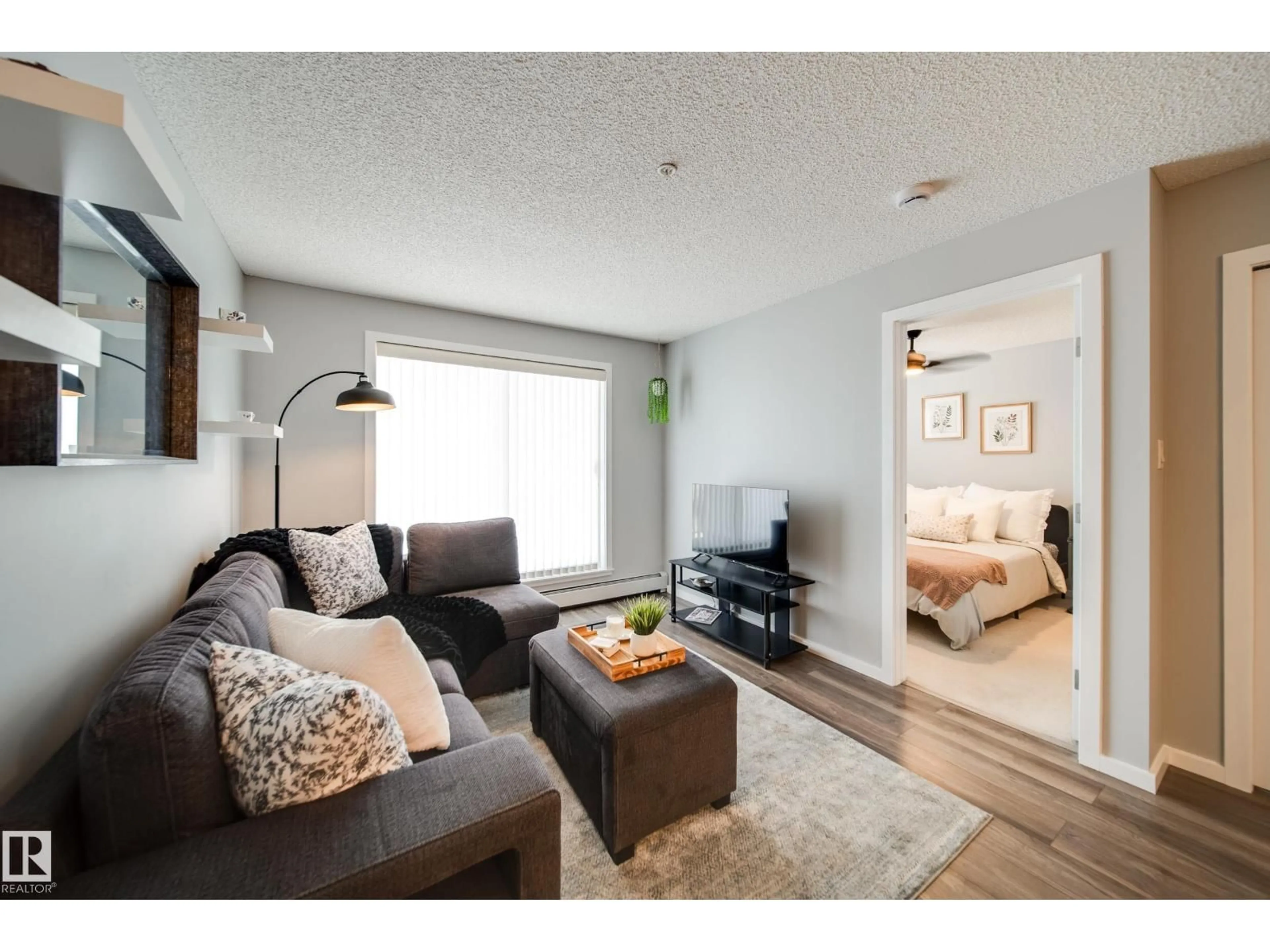 Living room with furniture, wood/laminate floor for #346 - 1196 HYNDMAN RD, Edmonton Alberta T5A0X8