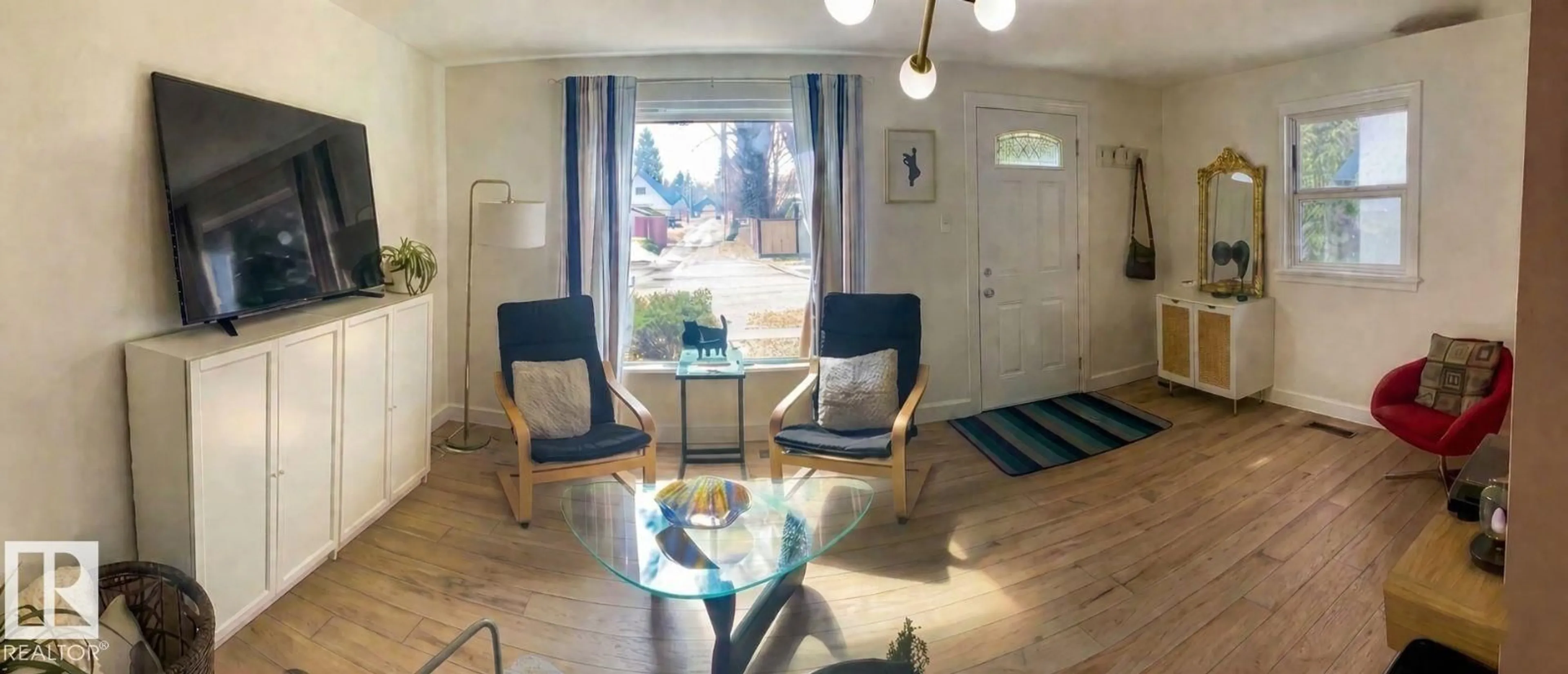 Living room with furniture, wood/laminate floor for 14520 104 AV, Edmonton Alberta T5N0X2
