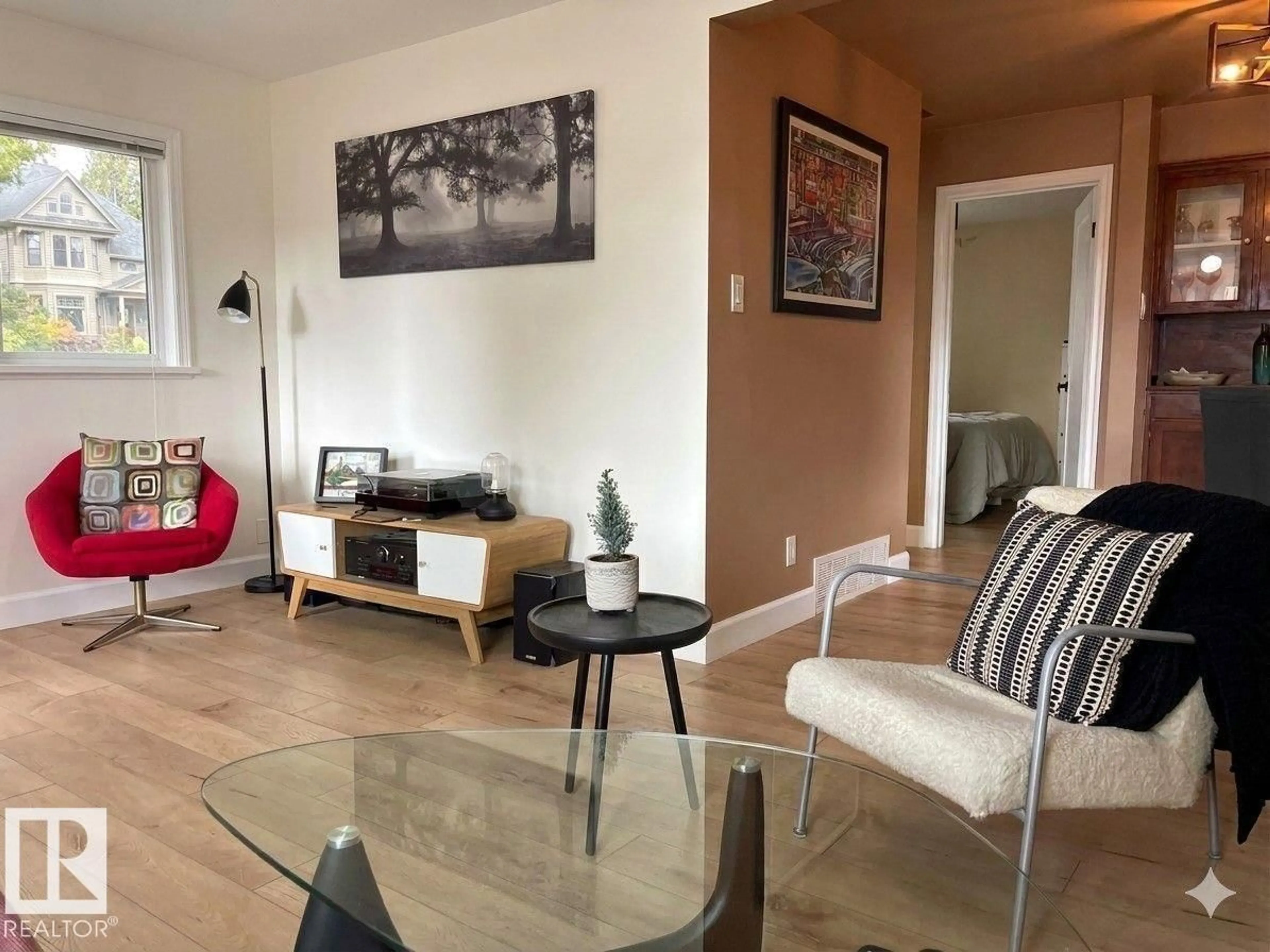 Living room with furniture, wood/laminate floor for 14520 104 AV, Edmonton Alberta T5N0X2