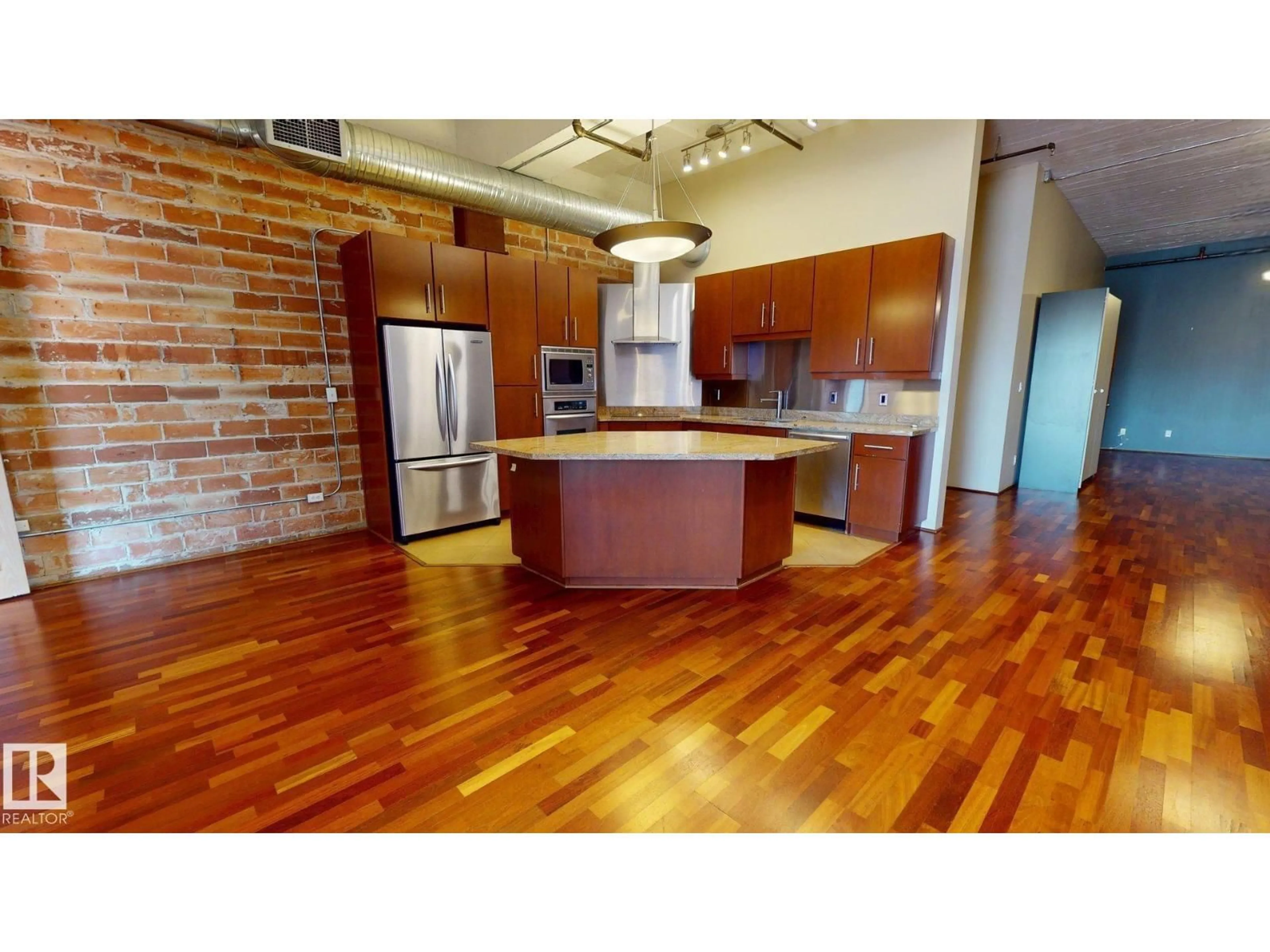 Open concept kitchen, wood/laminate floor for #241 - 10309 107 ST, Edmonton Alberta T5J0J2