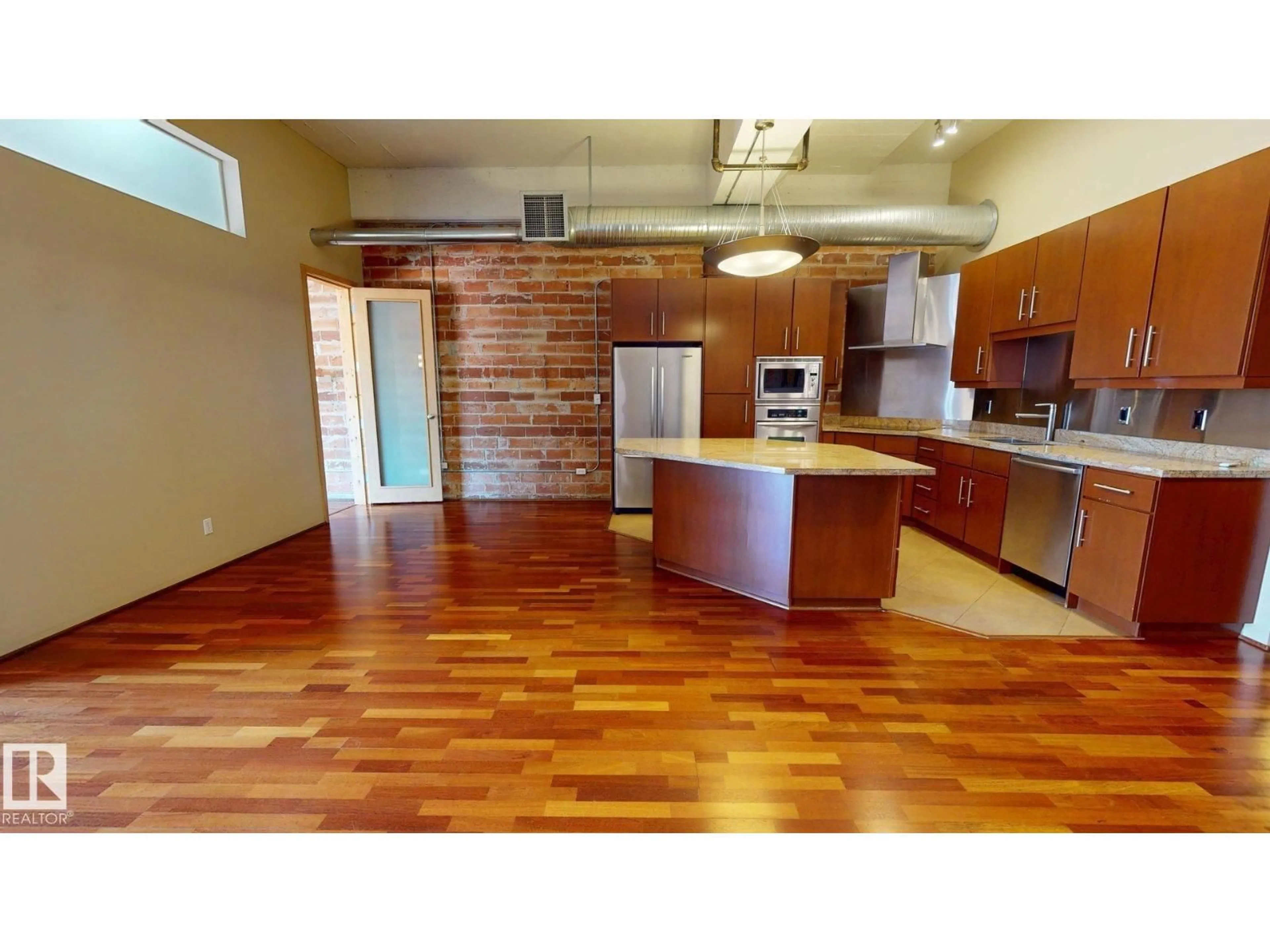 Open concept kitchen, wood/laminate floor for #241 - 10309 107 ST, Edmonton Alberta T5J0J2