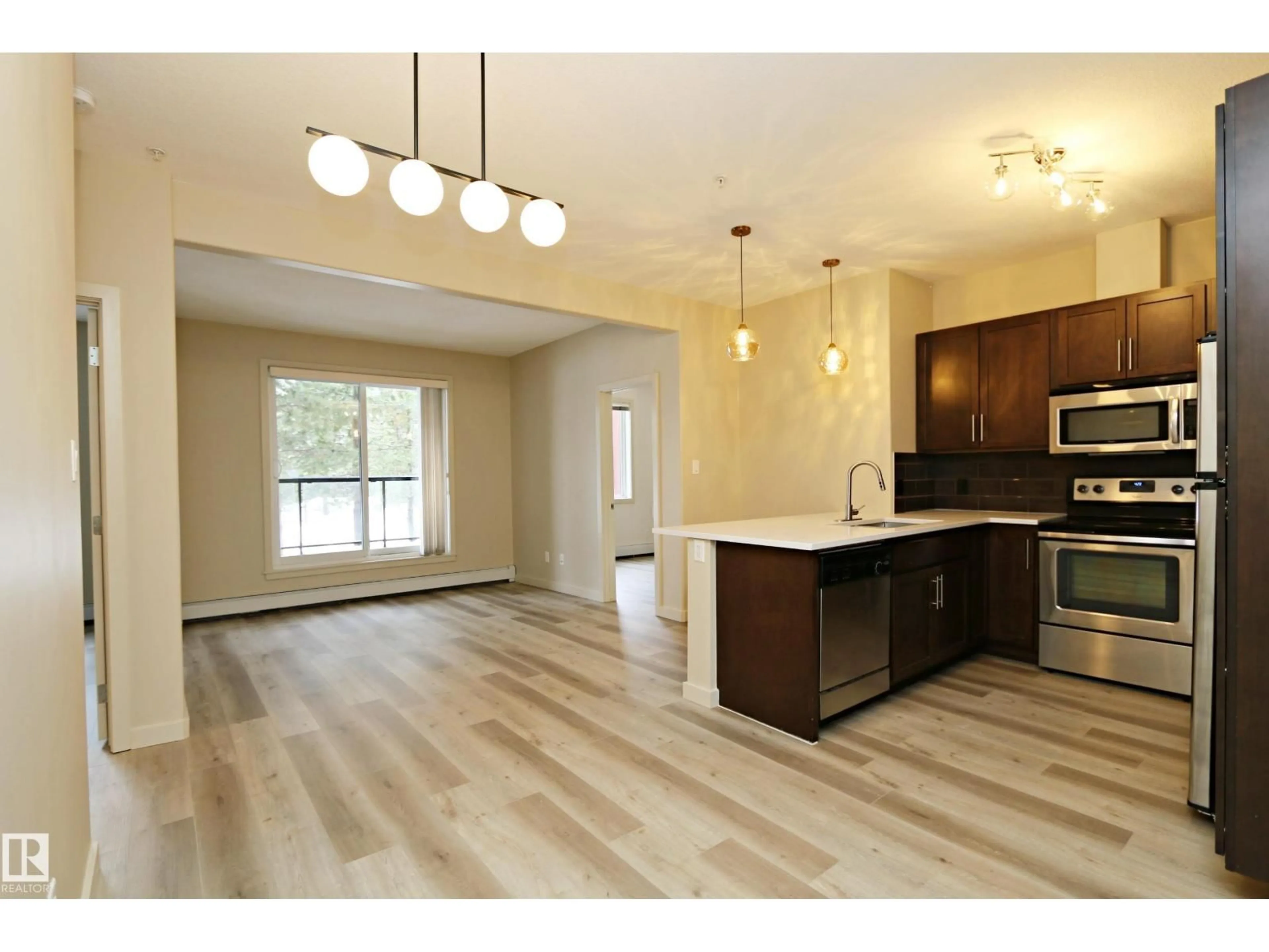 Open concept kitchen, wood/laminate floor for 308 - 140 AMBLESIDE LINK LI, Edmonton Alberta T6W0V3