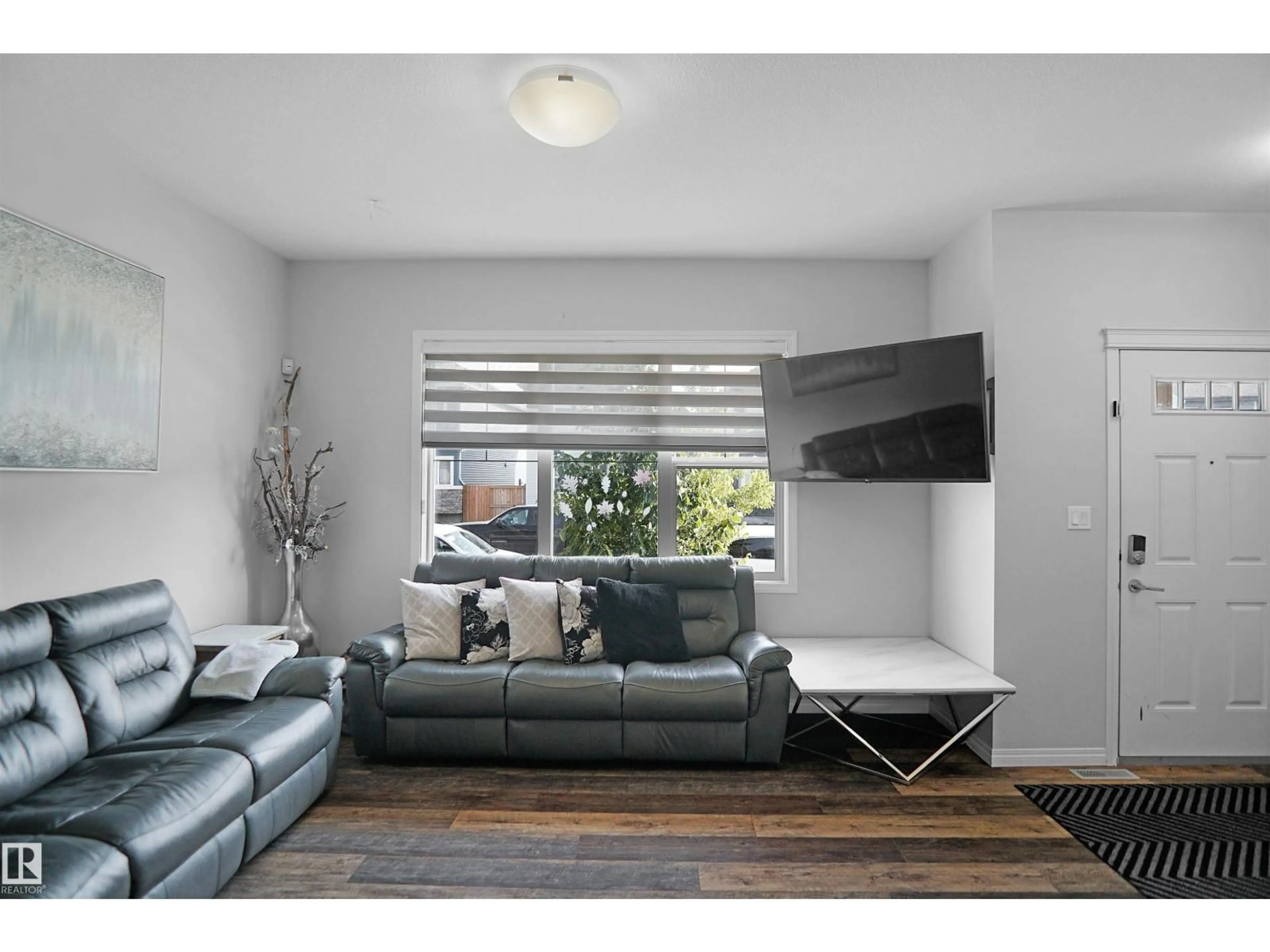 Living room with furniture, wood/laminate floor for NW - 17916 62 ST, Edmonton Alberta T5Y3Z4