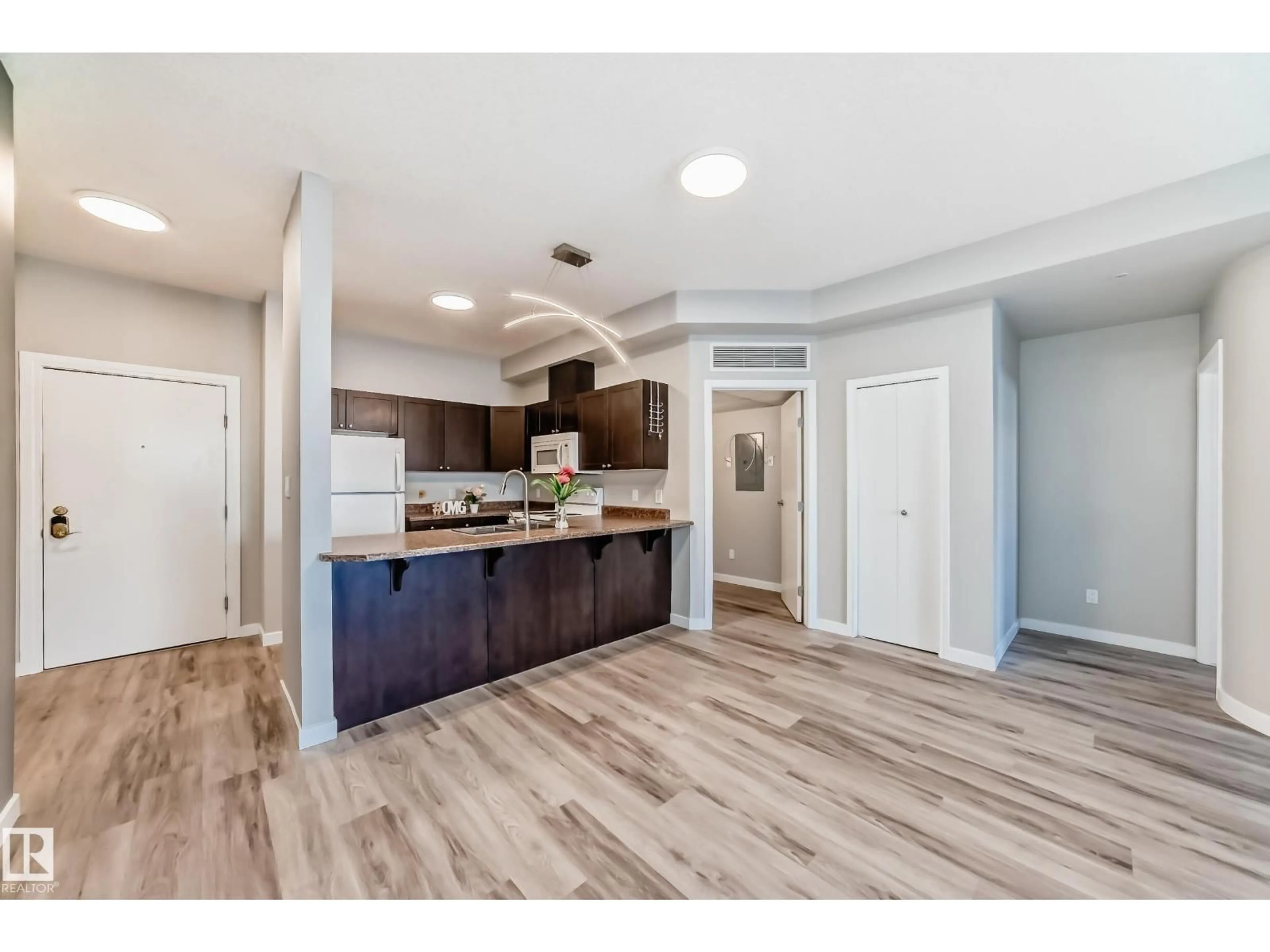 Open concept kitchen, wood/laminate floor for 105 - 4316 139 AV, Edmonton Alberta T5Y0L1