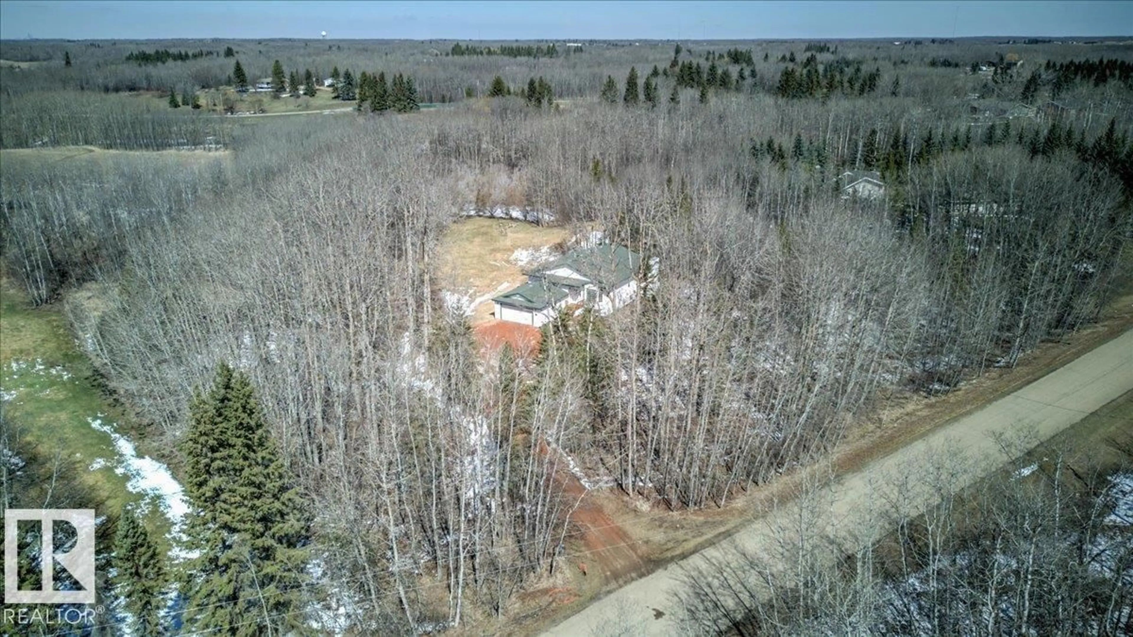 A pic from outside/outdoor area/front of a property/back of a property/a pic from drone, forest/trees view for 310 - 50247 RGE RD, Rural Leduc County Alberta T4X0K9
