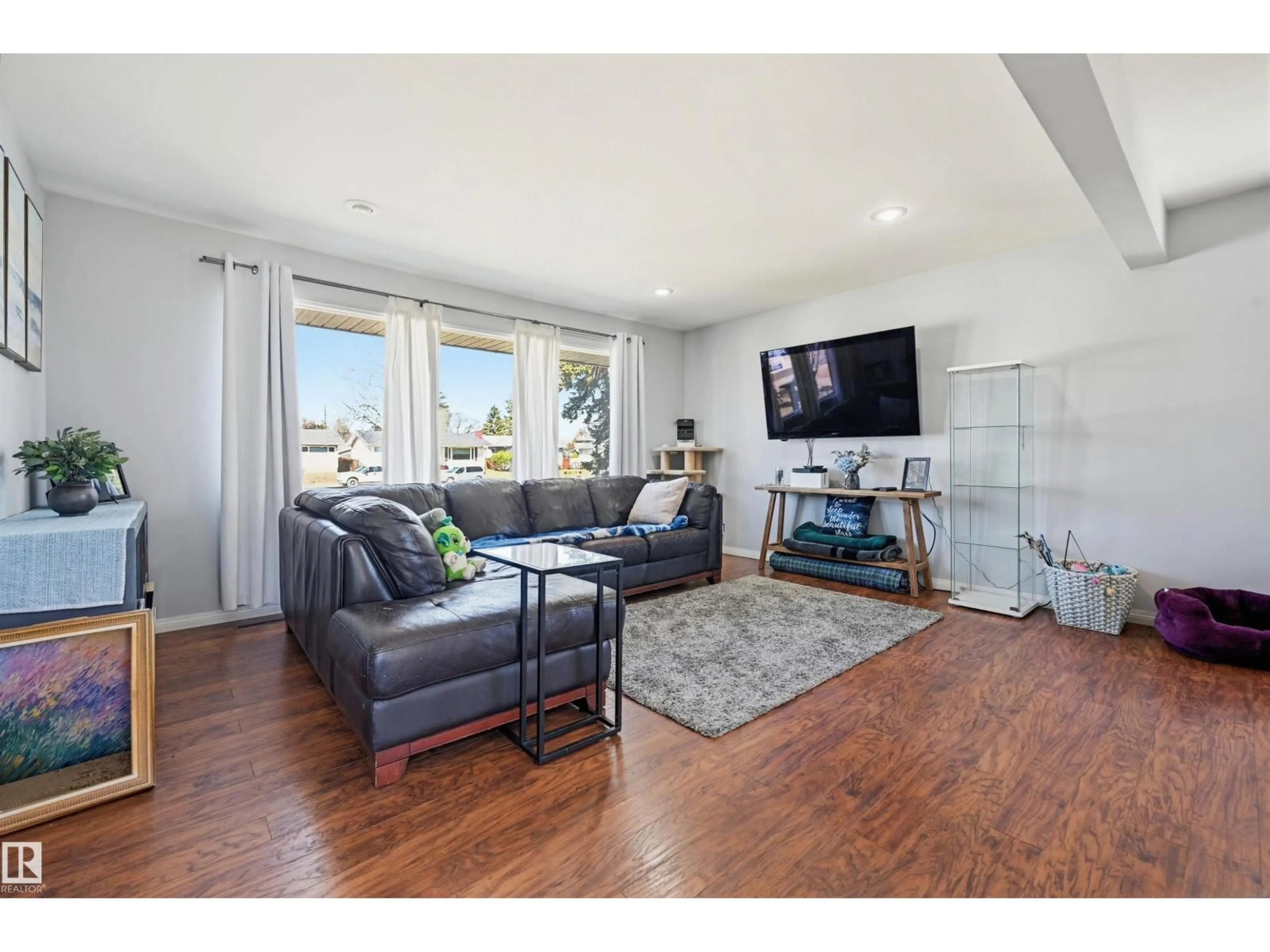 Living room with furniture, wood/laminate floor for 8507 149 ST NW, Edmonton Alberta T5R1B3