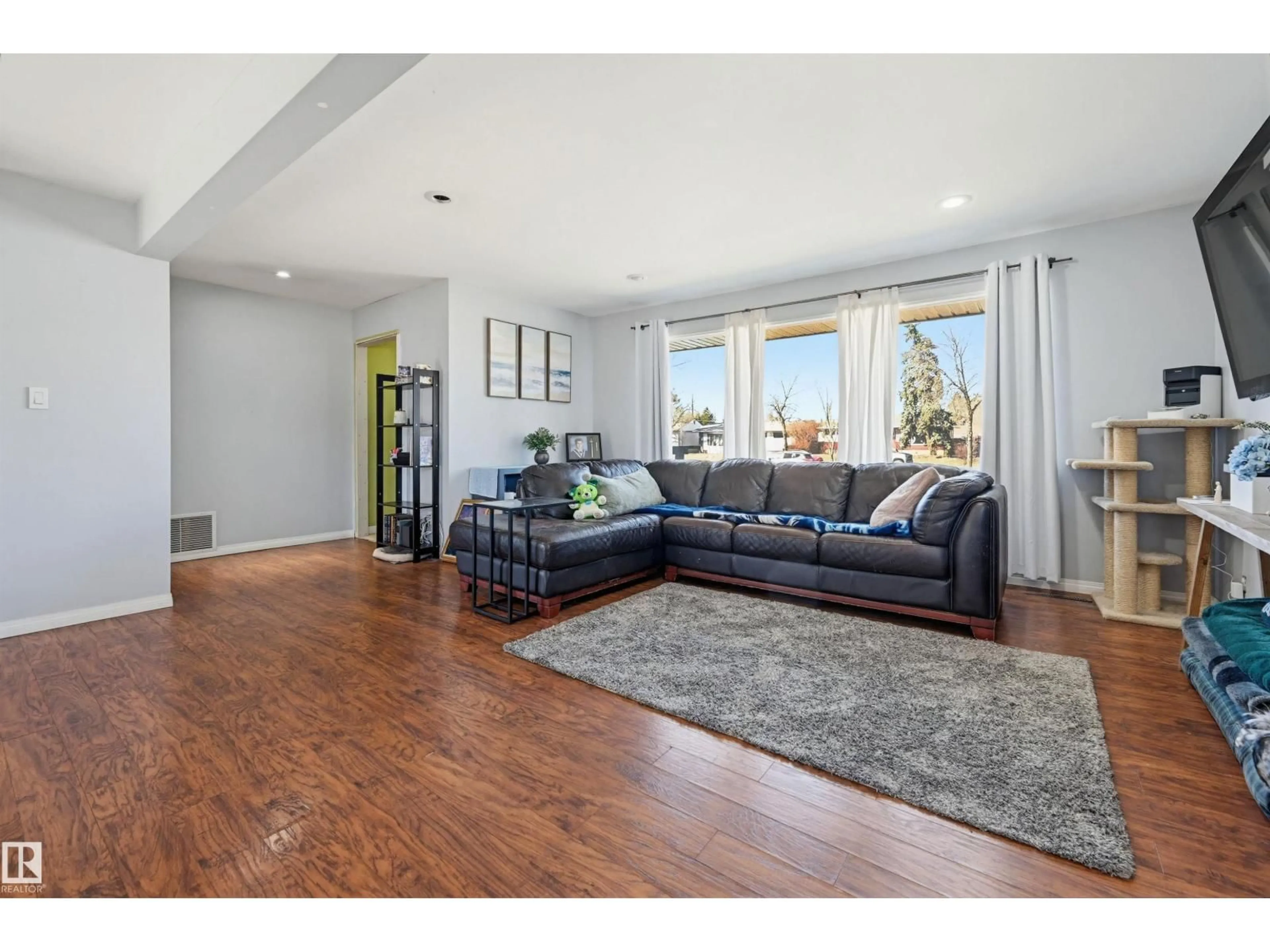 Living room with furniture, wood/laminate floor for 8507 149 ST NW, Edmonton Alberta T5R1B3
