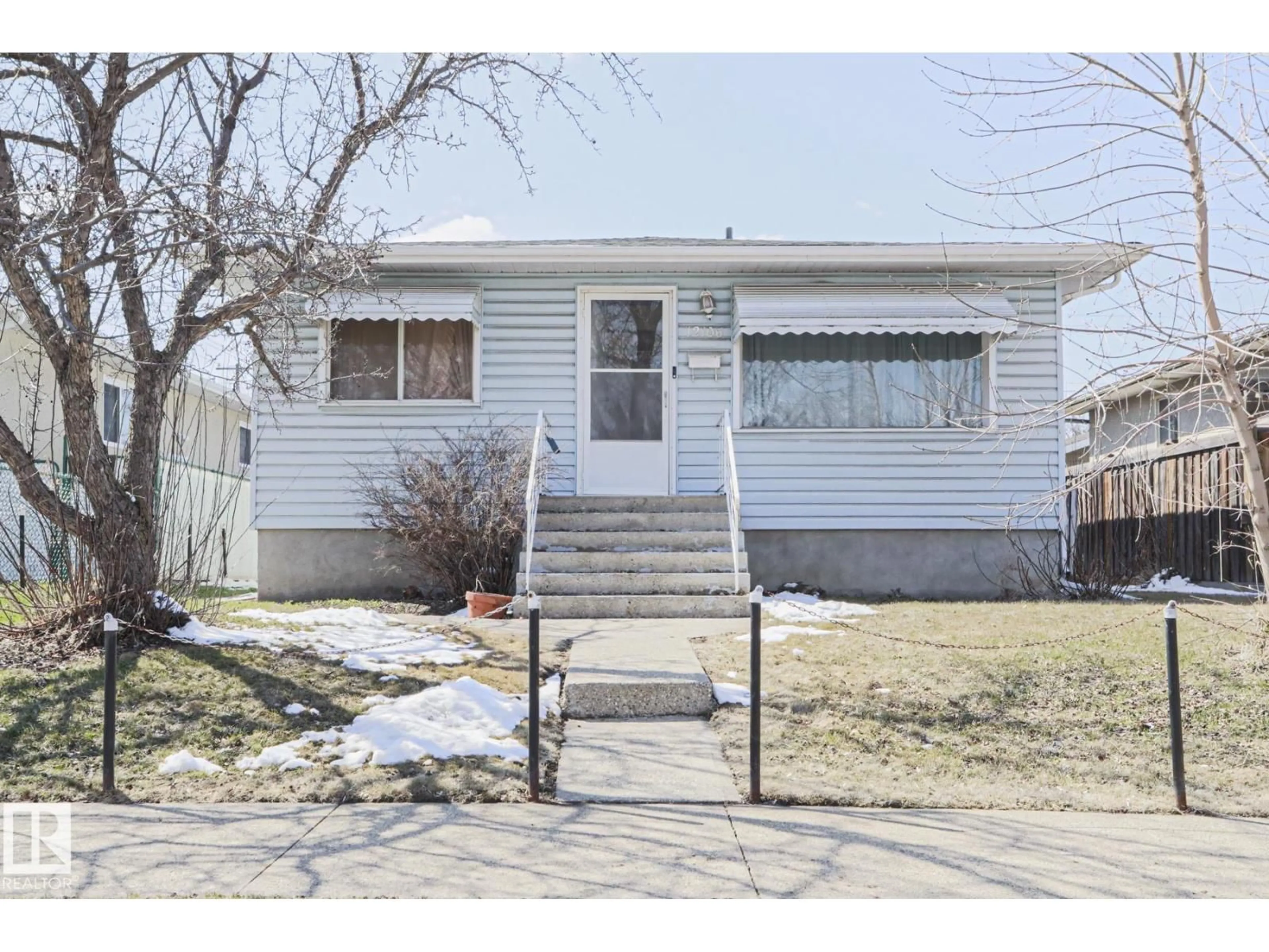 Home with vinyl exterior material, street for 12106 43 ST, Edmonton Alberta T5W2R1