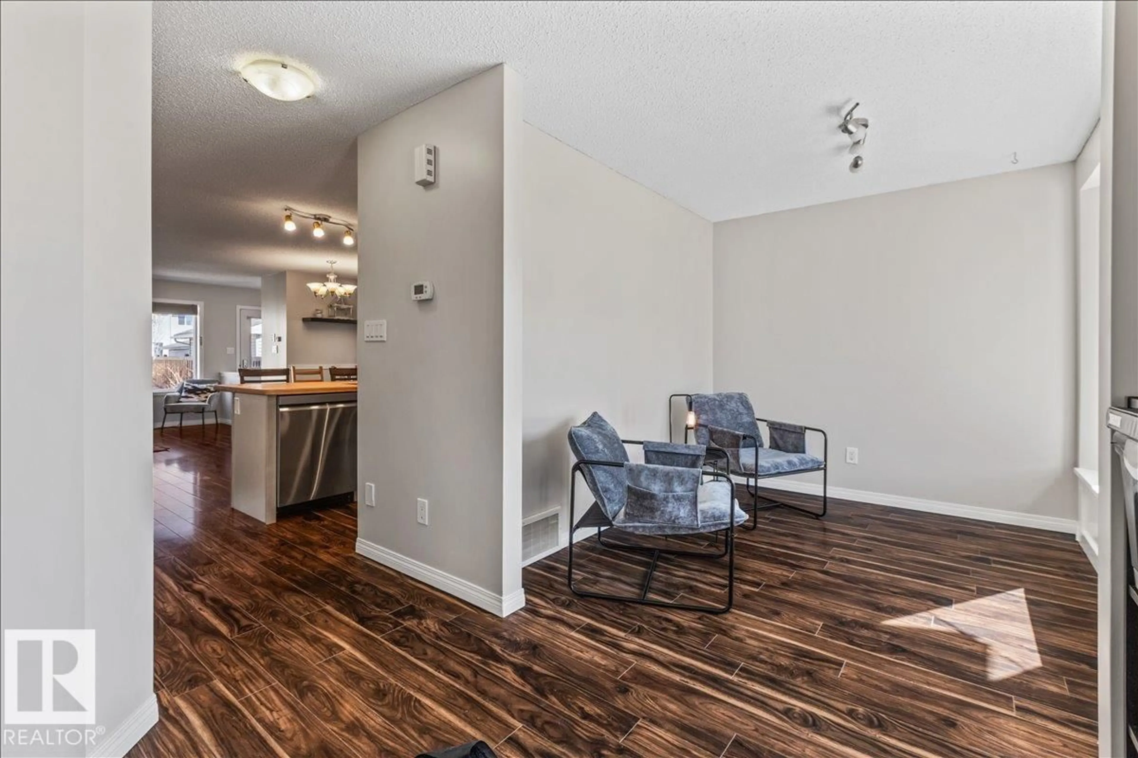 Living room with furniture, wood/laminate floor for 9310 SIMPSON DR, Edmonton Alberta T6R0E4