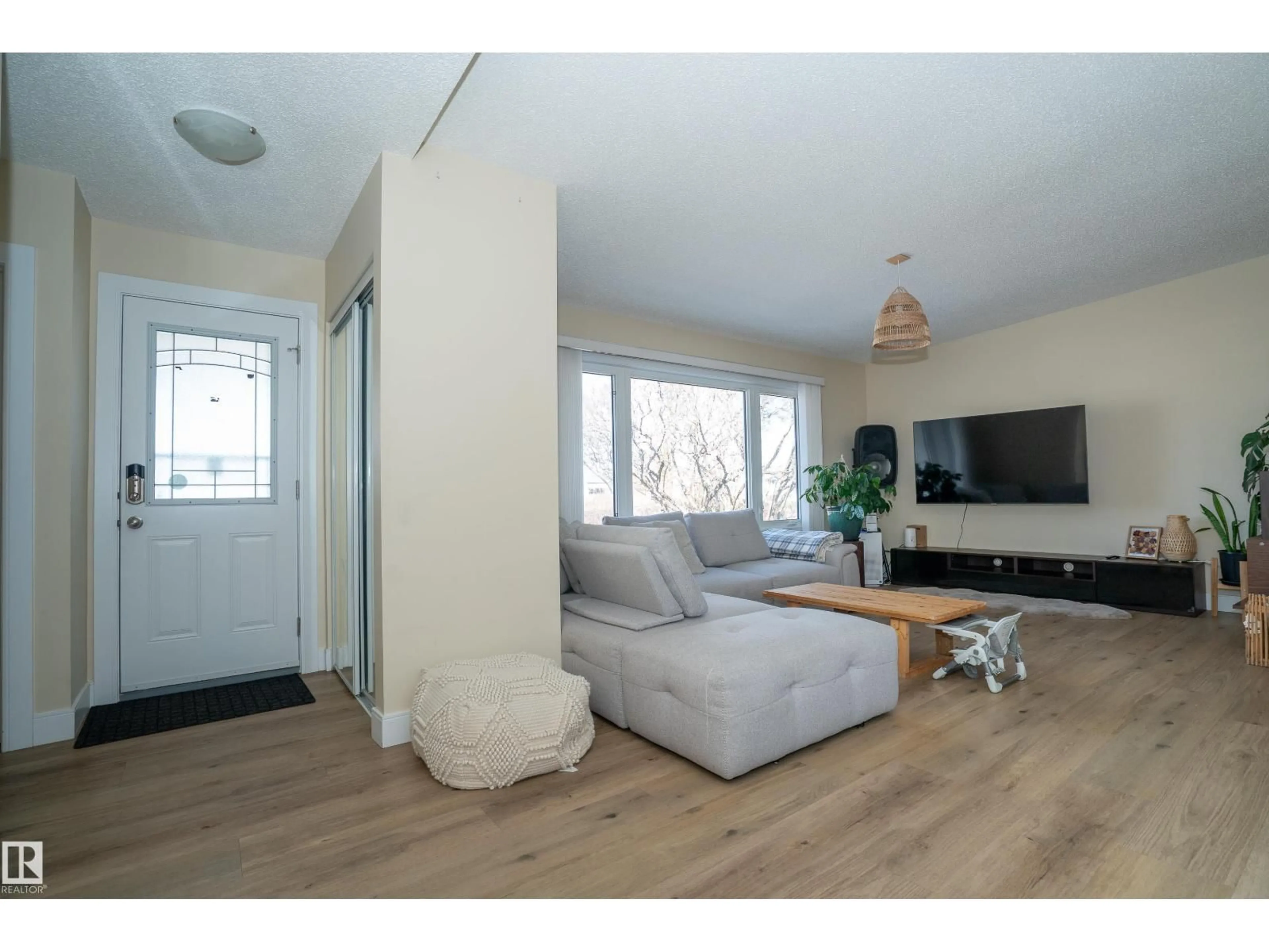 Living room with furniture, wood/laminate floor for 7807 132 AV, Edmonton Alberta T5C2B2