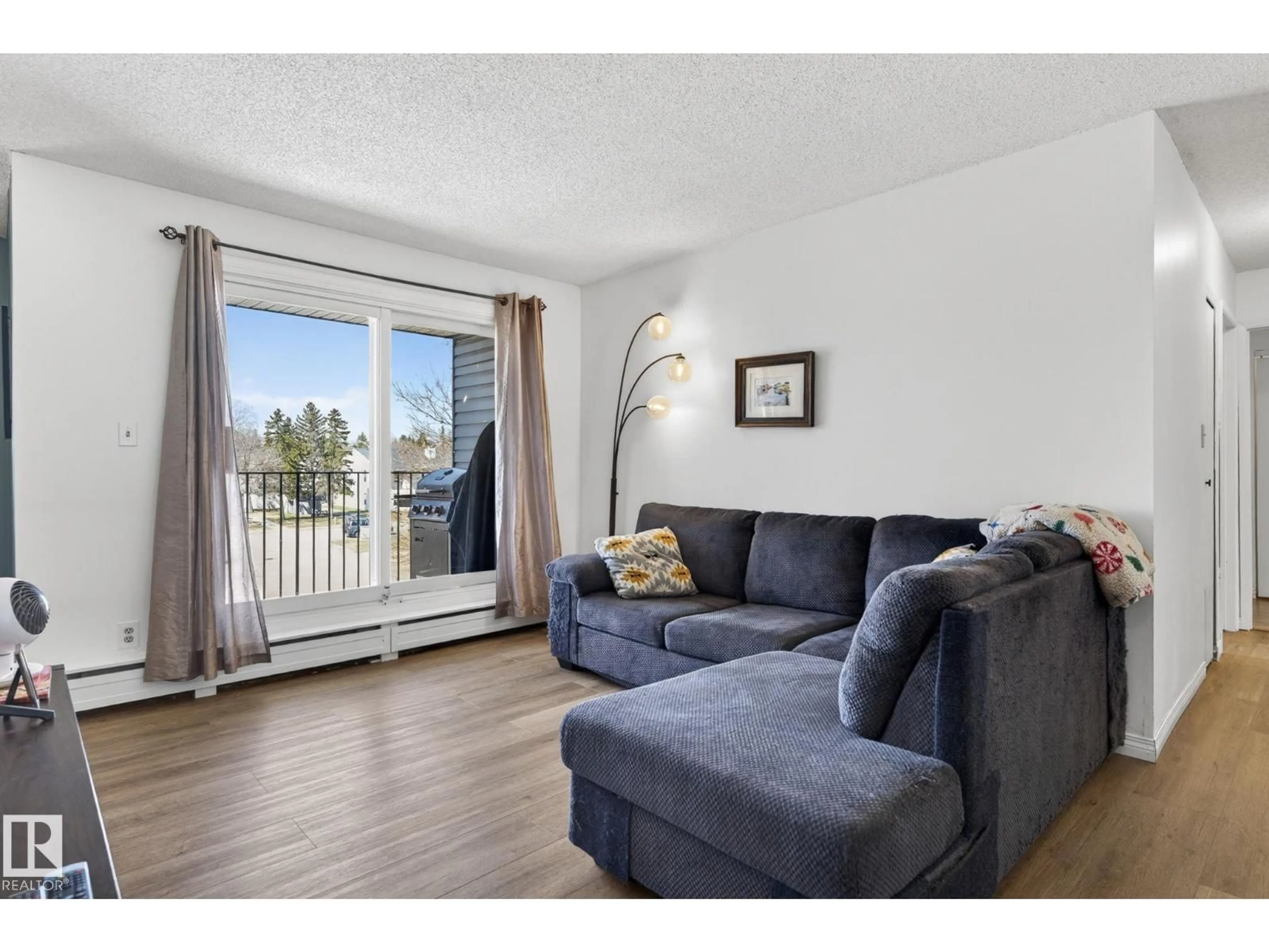 Living room with furniture, wood/laminate floor for 301 - 7203 171 ST NW, Edmonton Alberta T5T2R1